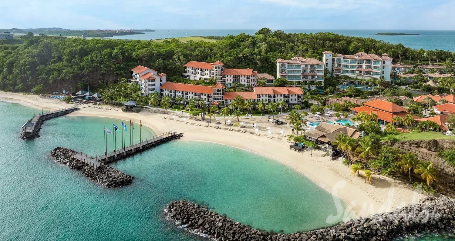 Sandals Grenada resort on Pink Gin Beach at golden hour with palm trees and Caribbean Sea, Grenada