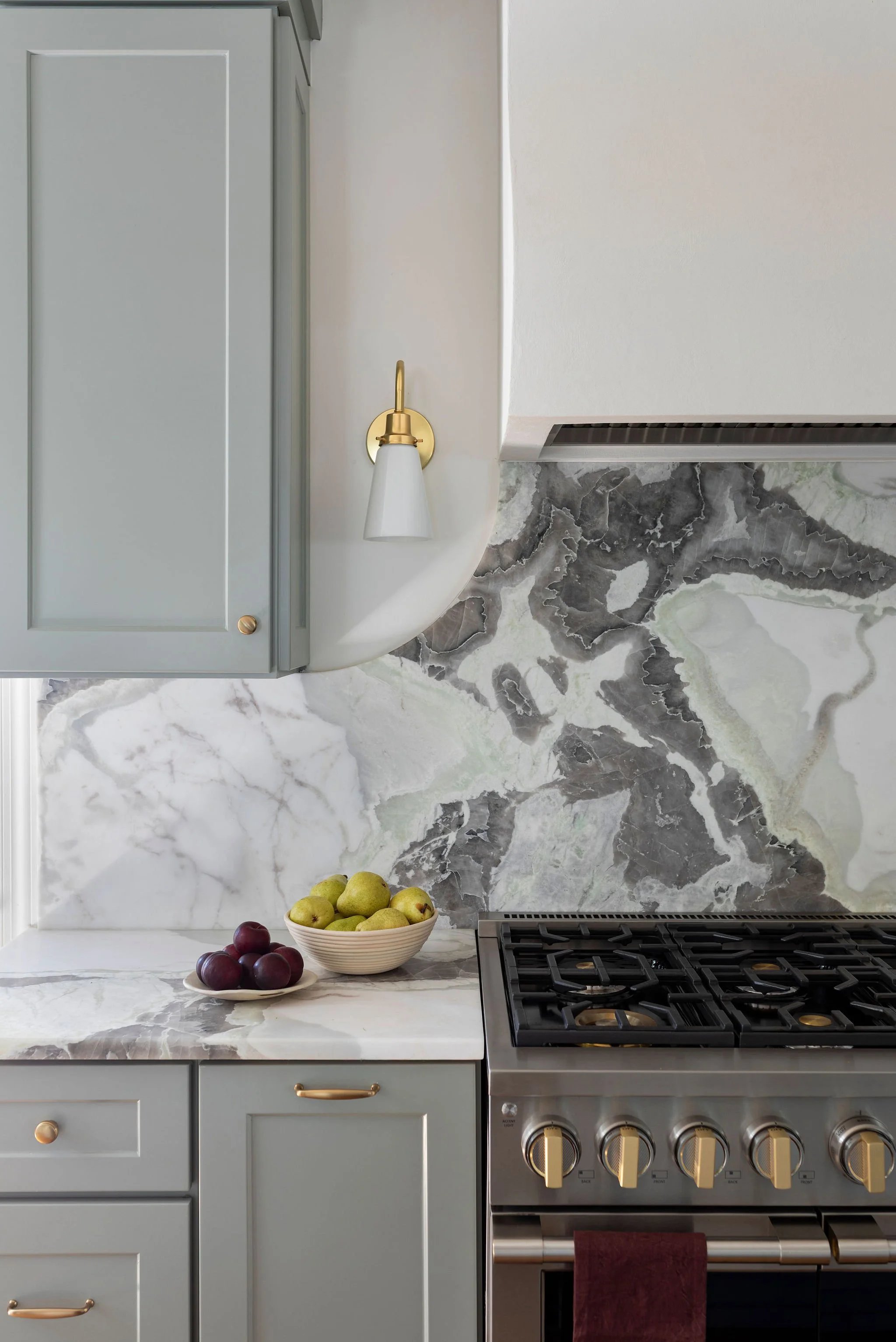 Luxury kitchen renovation with custom marble countertops and backsplash.