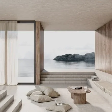 Modern living room with large glass door leading outside, overlooking water and rocky landscape.