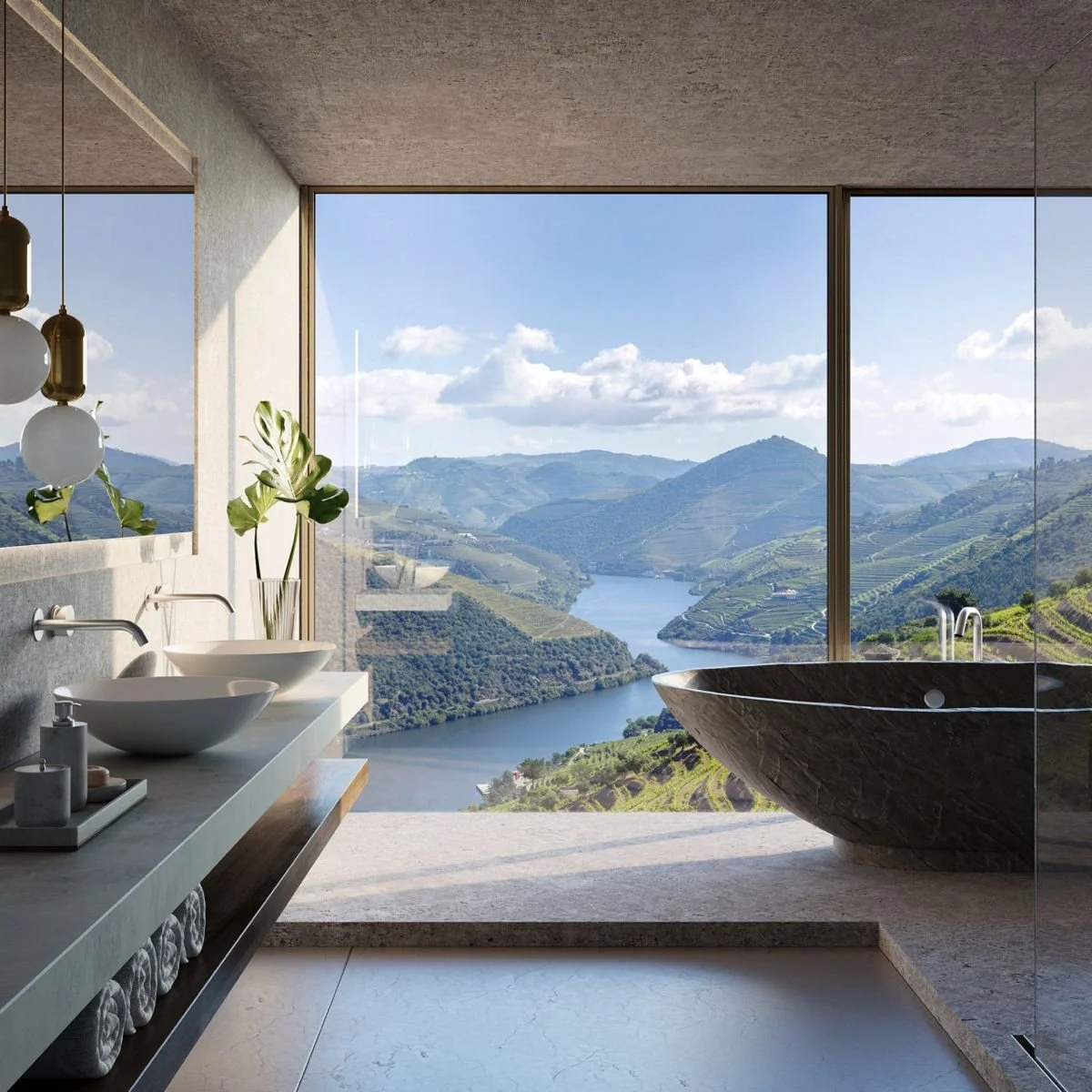 Modern bathroom with a freestanding bathtub overlooking a scenic river valley through large glass windows