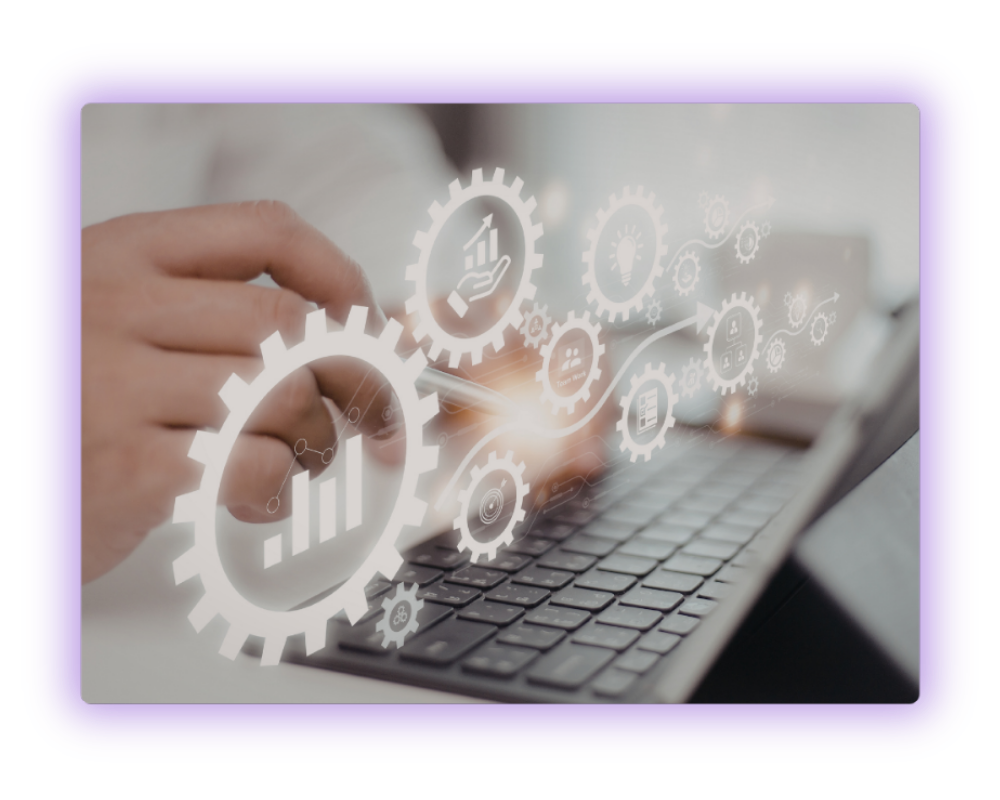 Person interacting with futuristic digital interface showing gears, charts, and icons over a laptop keyboard.