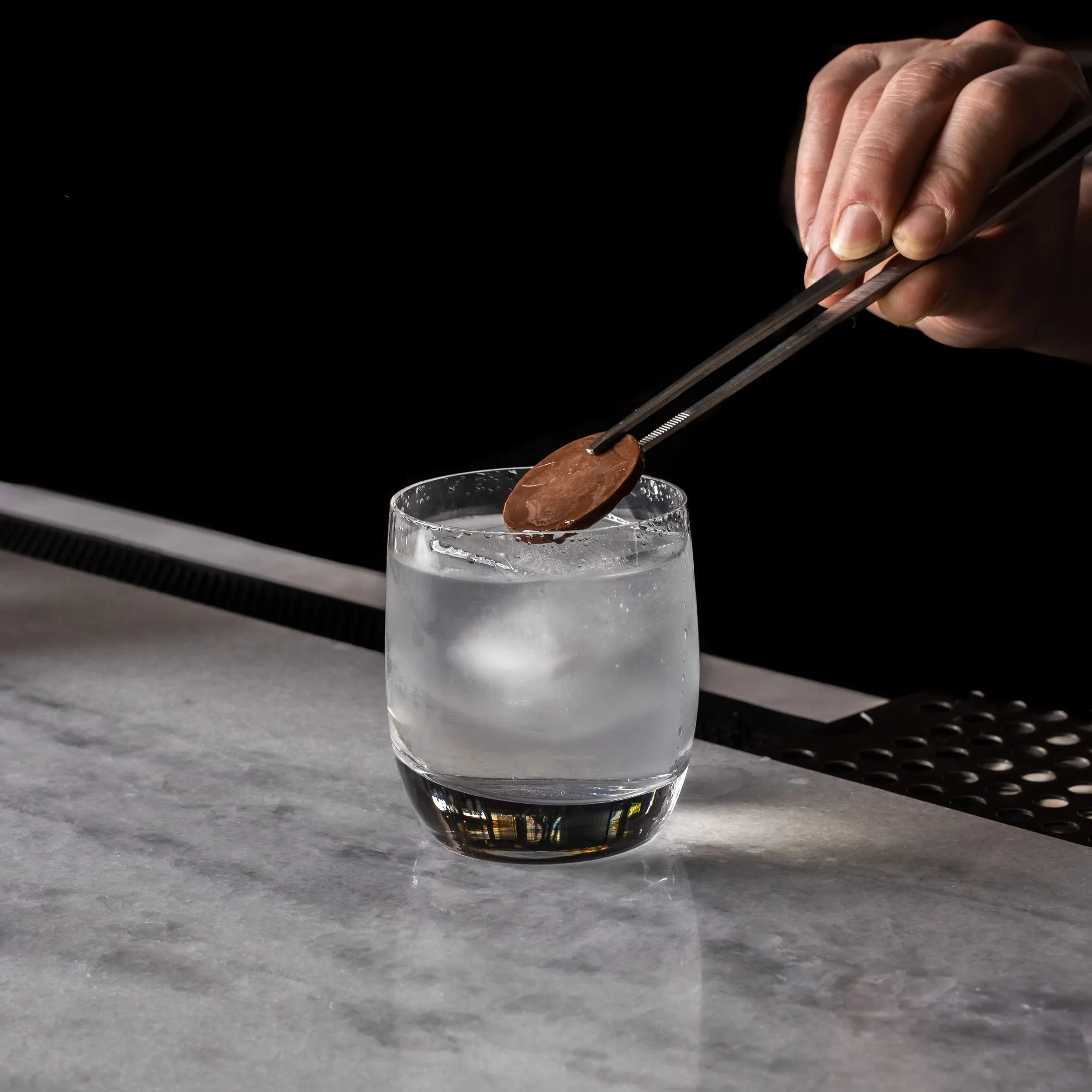 An old fashioned black and white cocktail