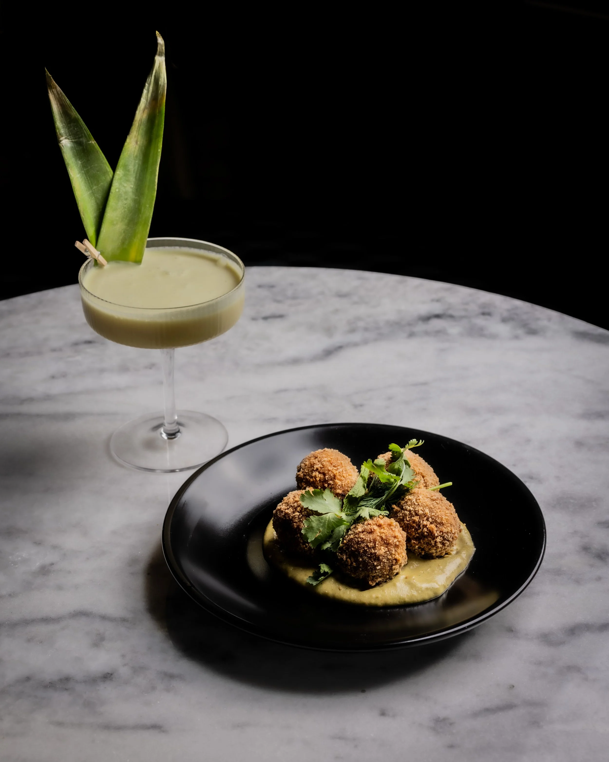 A cocktail and Biryani arancini