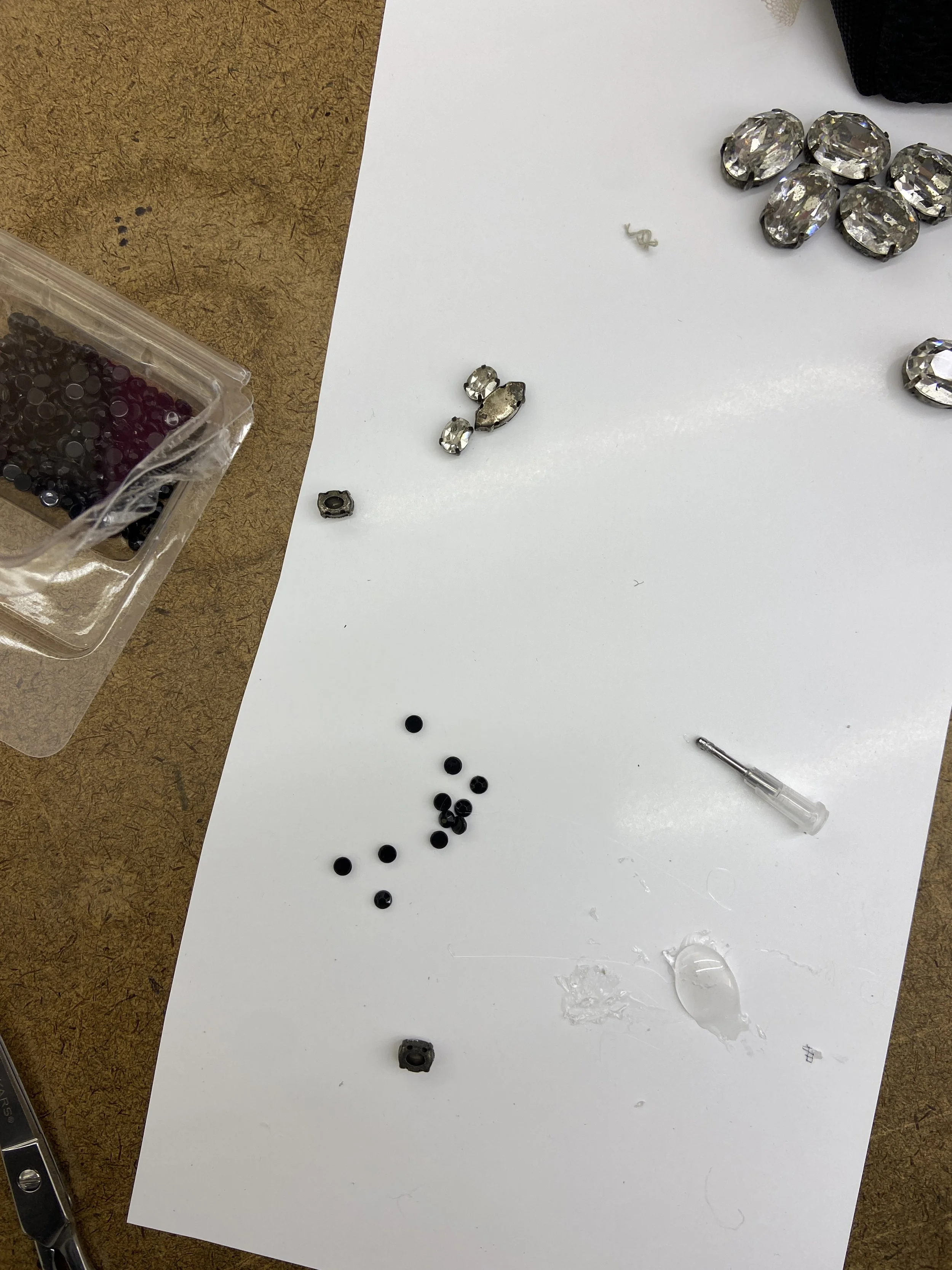 Attaching the small black stones and large clear crystals with E6000.