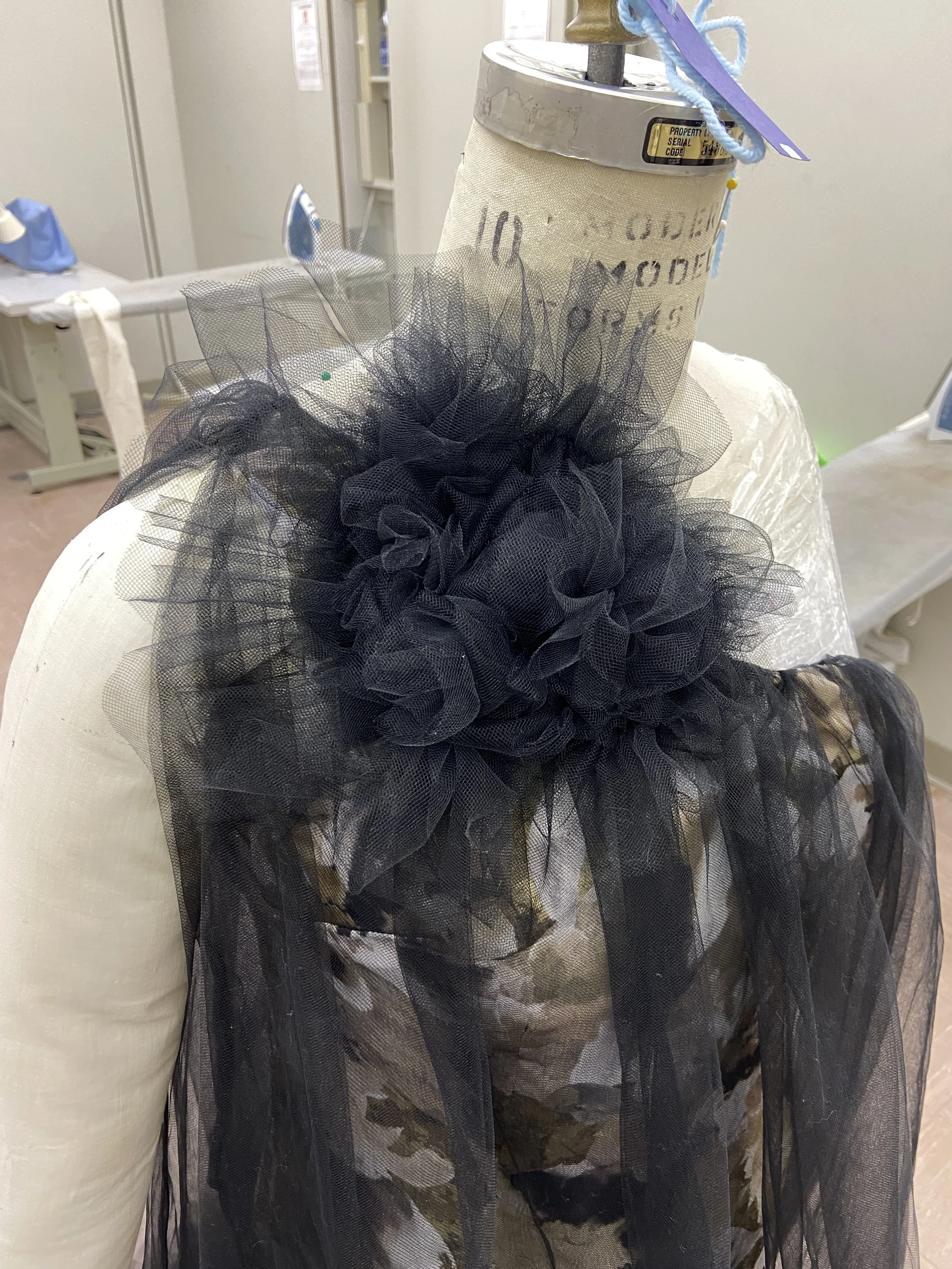 Left side view: The flower was then hand sewn through all layers, besides the lining, to the dress.