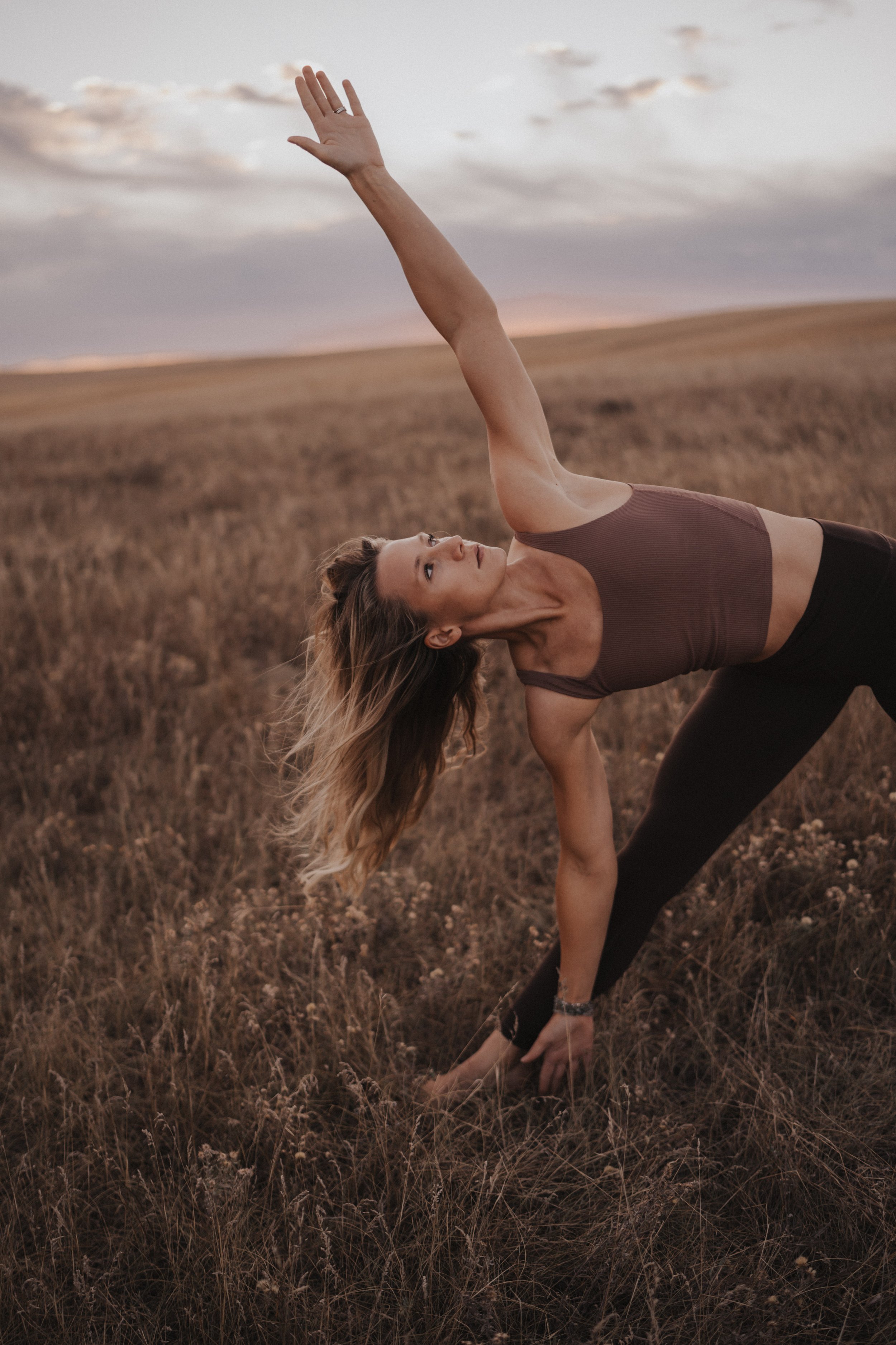 Woman doing yoga in field near Leduc, Alberta