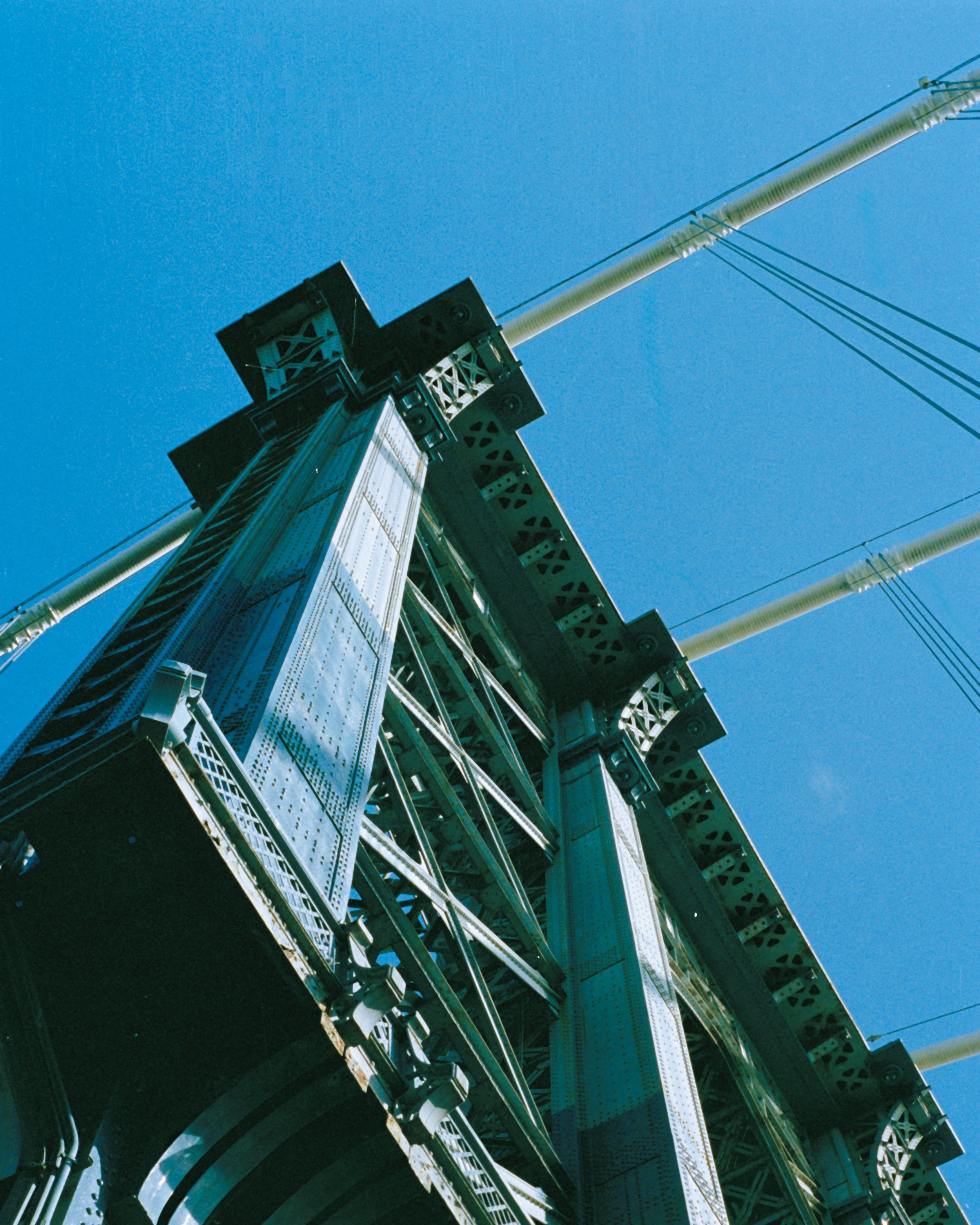 Close-up of a steel structure against a clear blue sky, showing large pipes and metal framework.