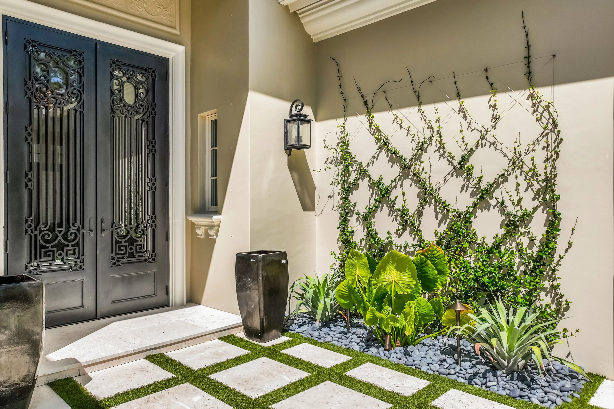 Private courtyard with living vine wall, ceramic water feature, and minimalist design.