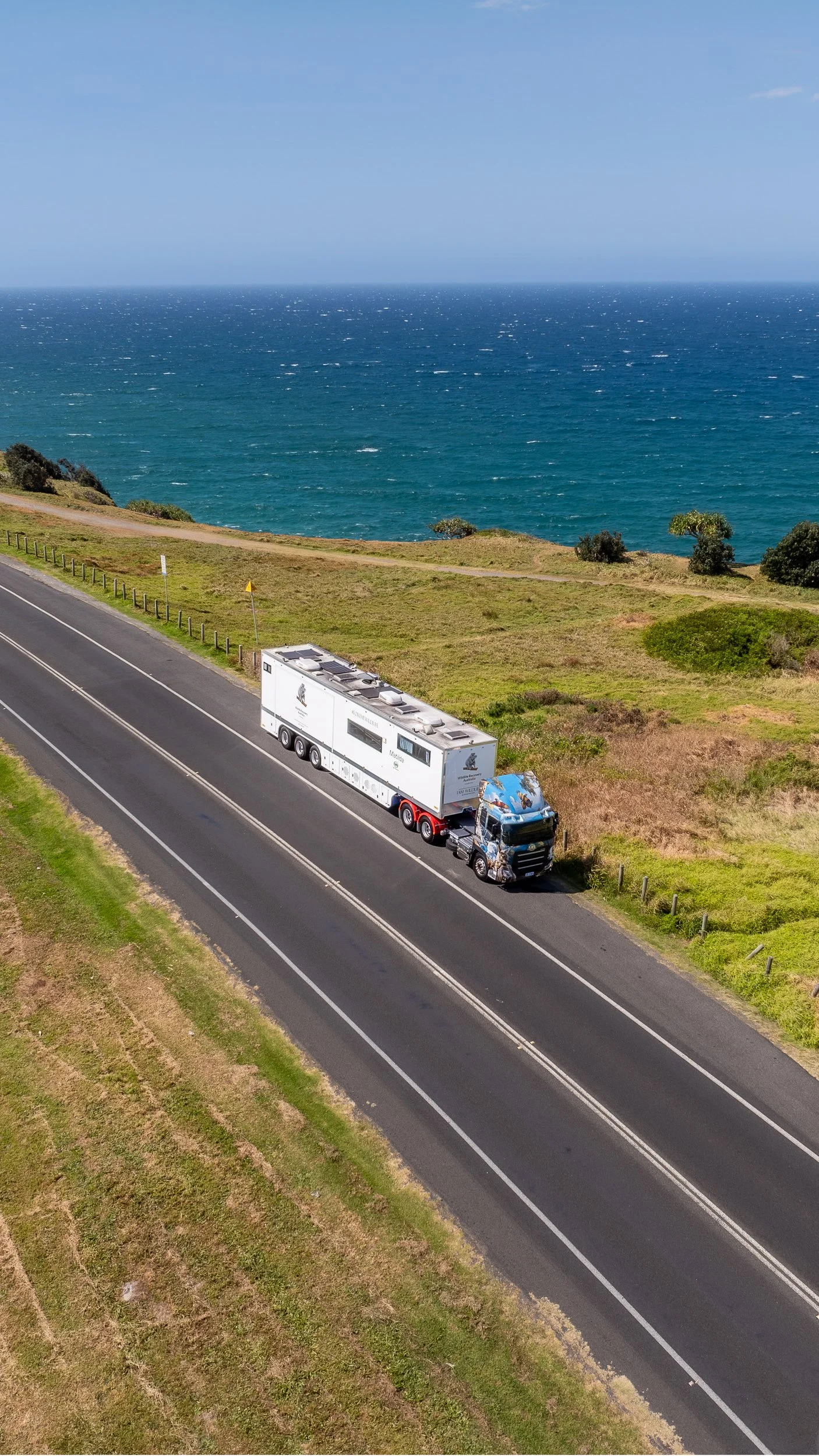 Australia's only mobile wildlife hospital driving along a coastal highway with the ocean in the background.