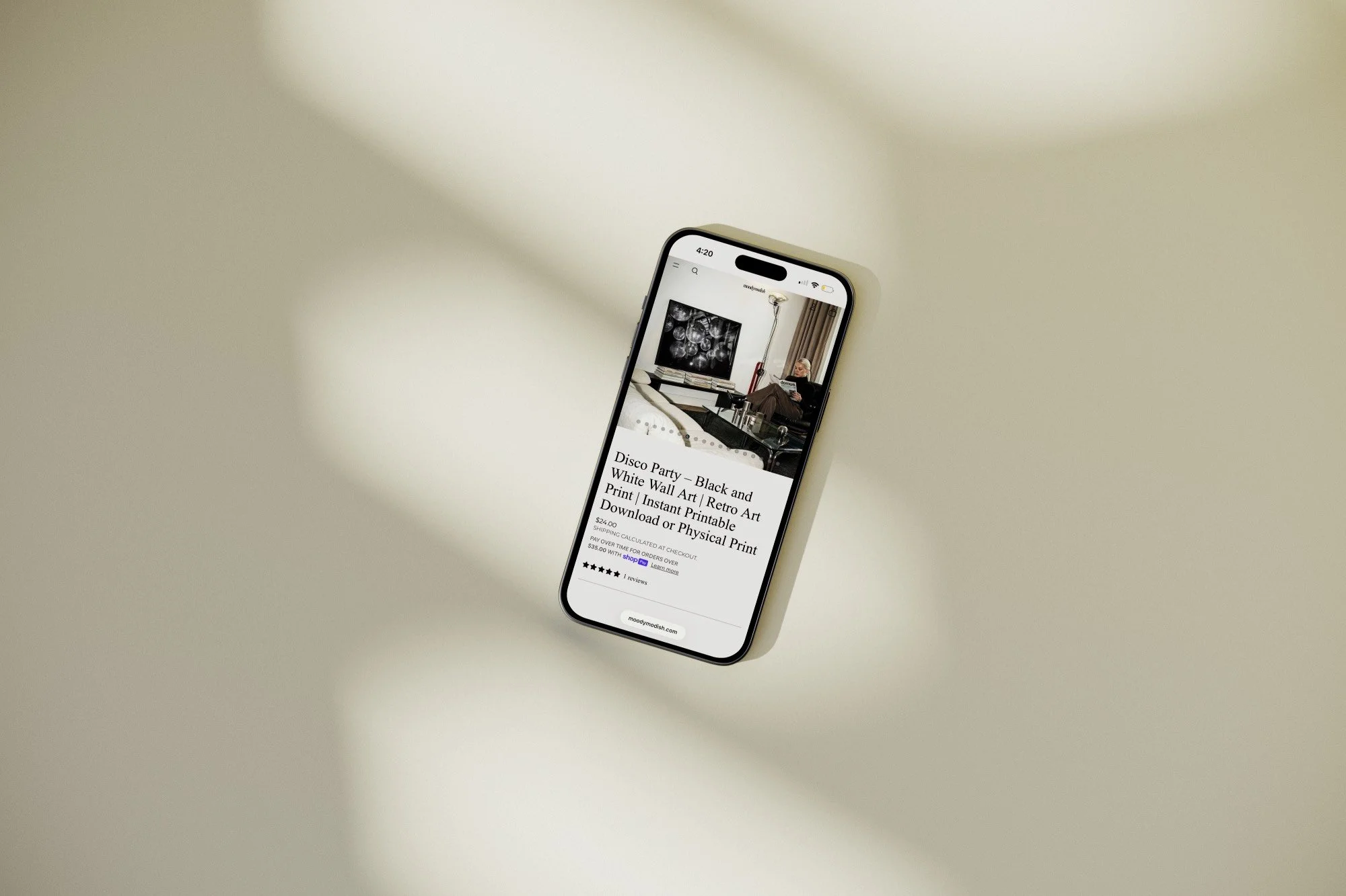 iPhone showing web site designed by 808 on iPhone screen against beige background