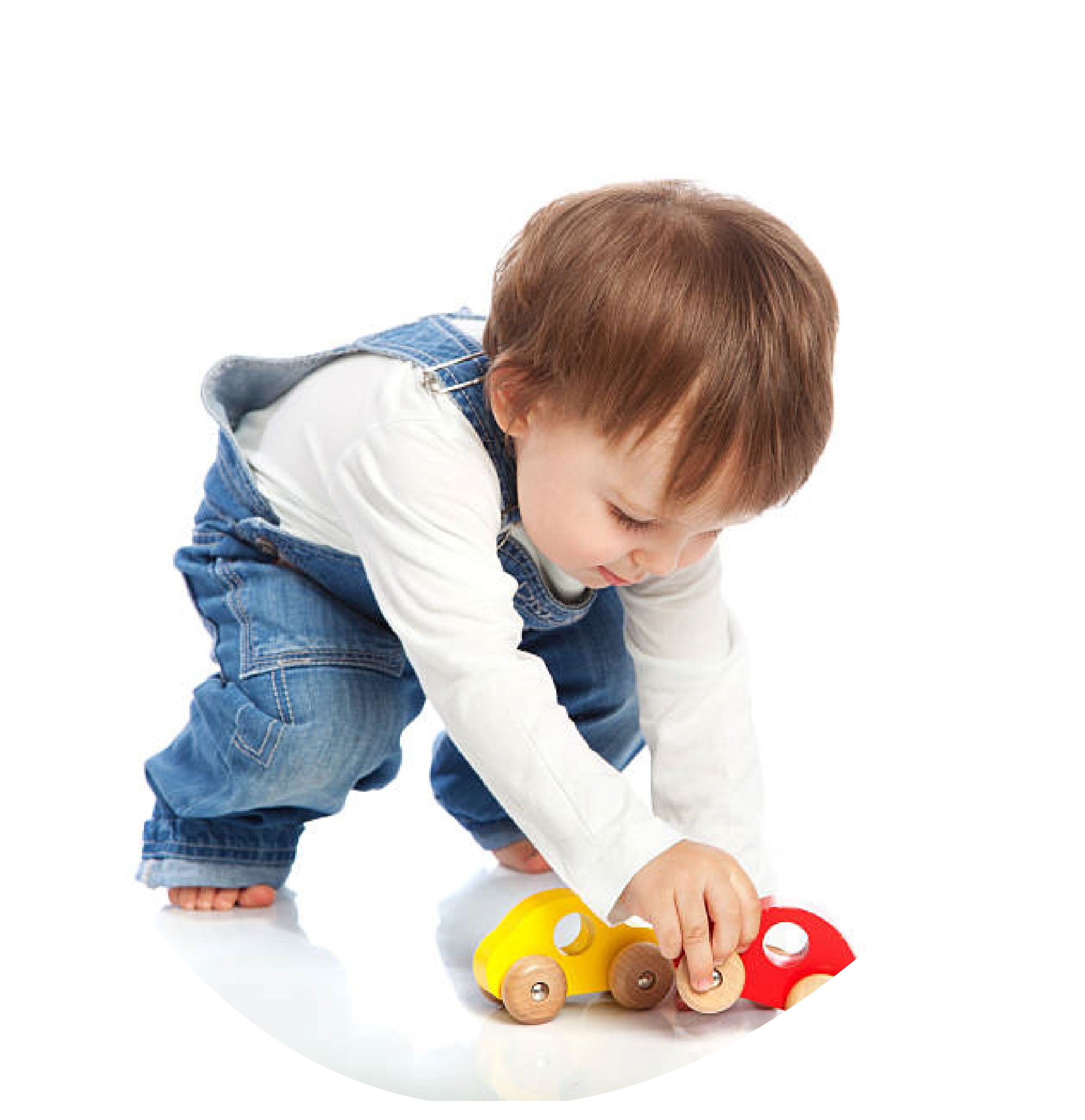 Young child with brown hair playing with yellow and red wooden toy cars on a white background.