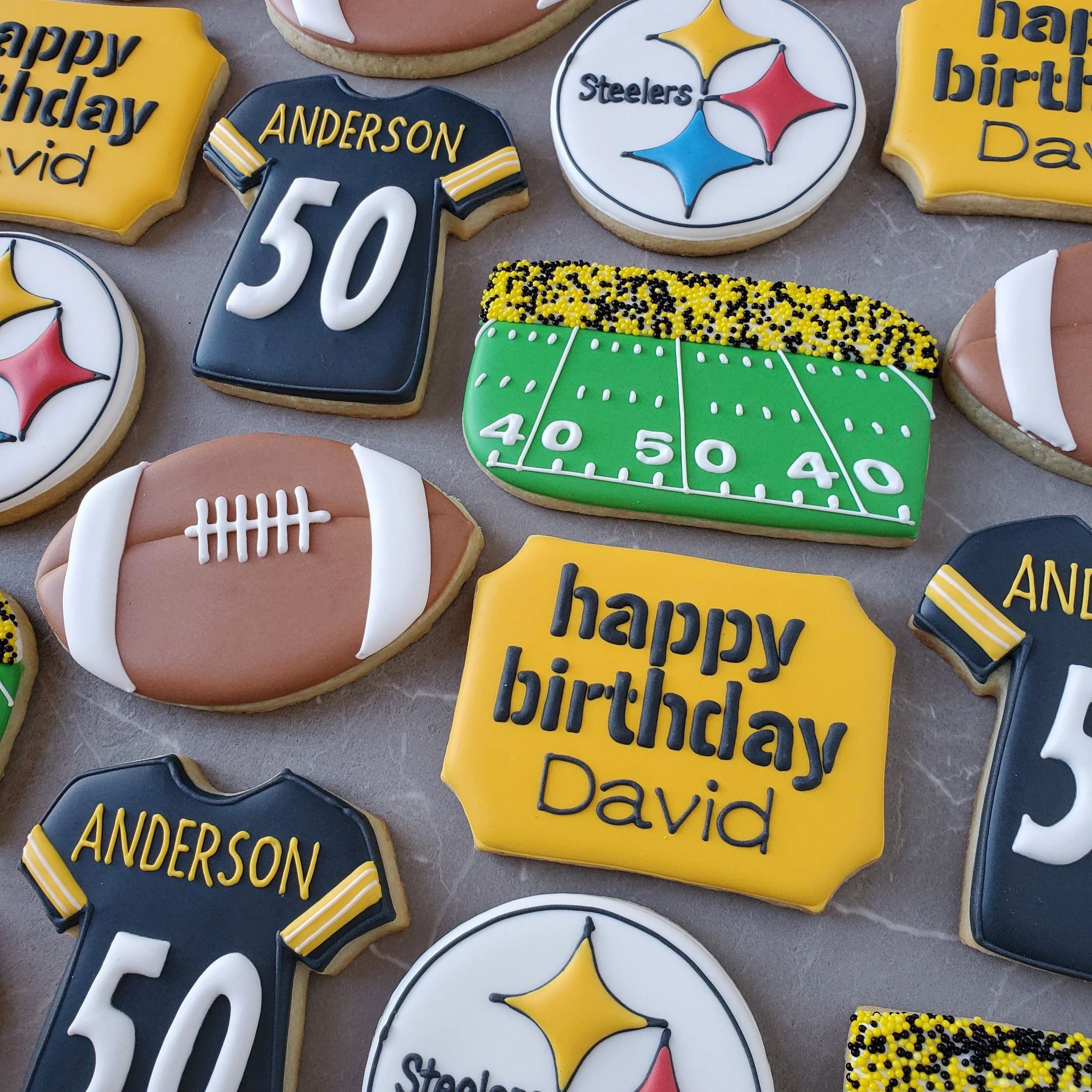 Football-themed cookies, birthday messages, and sports team logos for a celebration.