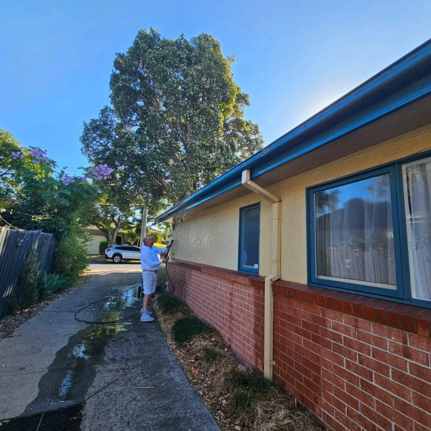 Exterior house pressure washing and surface preparation before painting