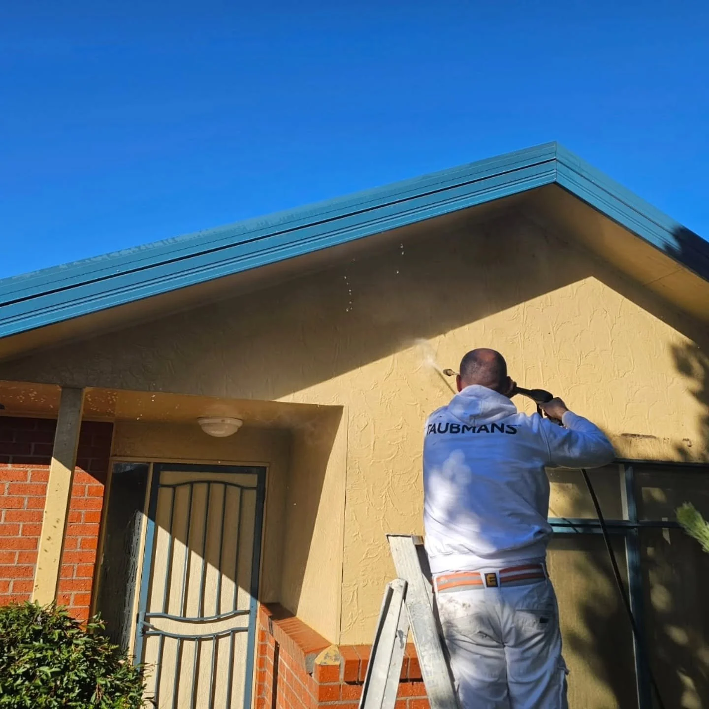 Exterior house pressure washing and surface preparation before painting