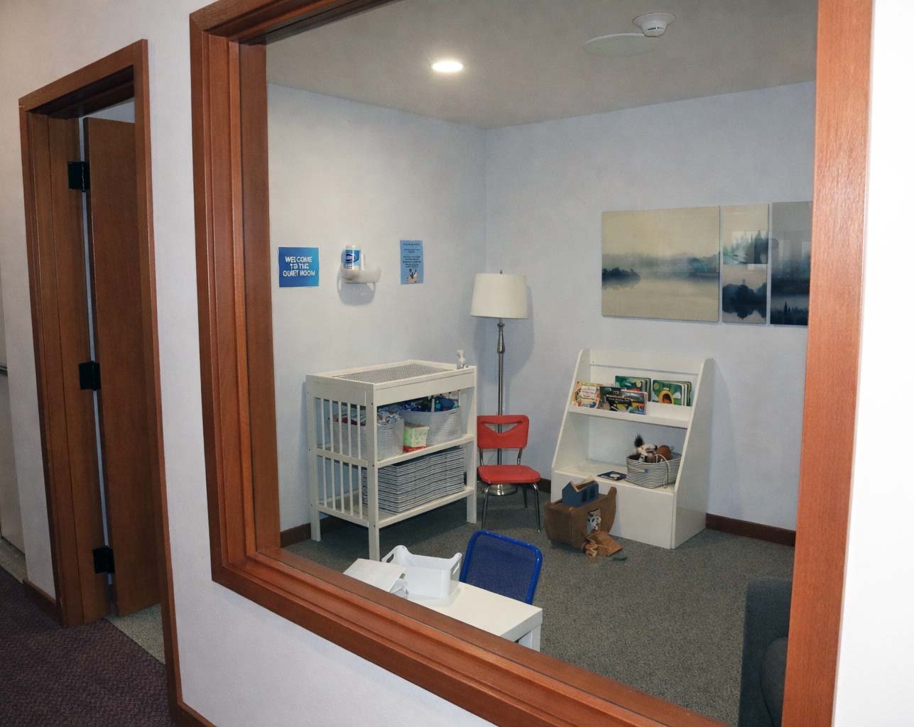 The Family Room has a rocker, changing table, a few toys, and a window into the sanctuary during the service.