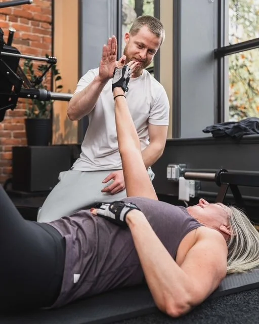 Photo where I'm showing support to my client. We have joy from hard work after workout is done.