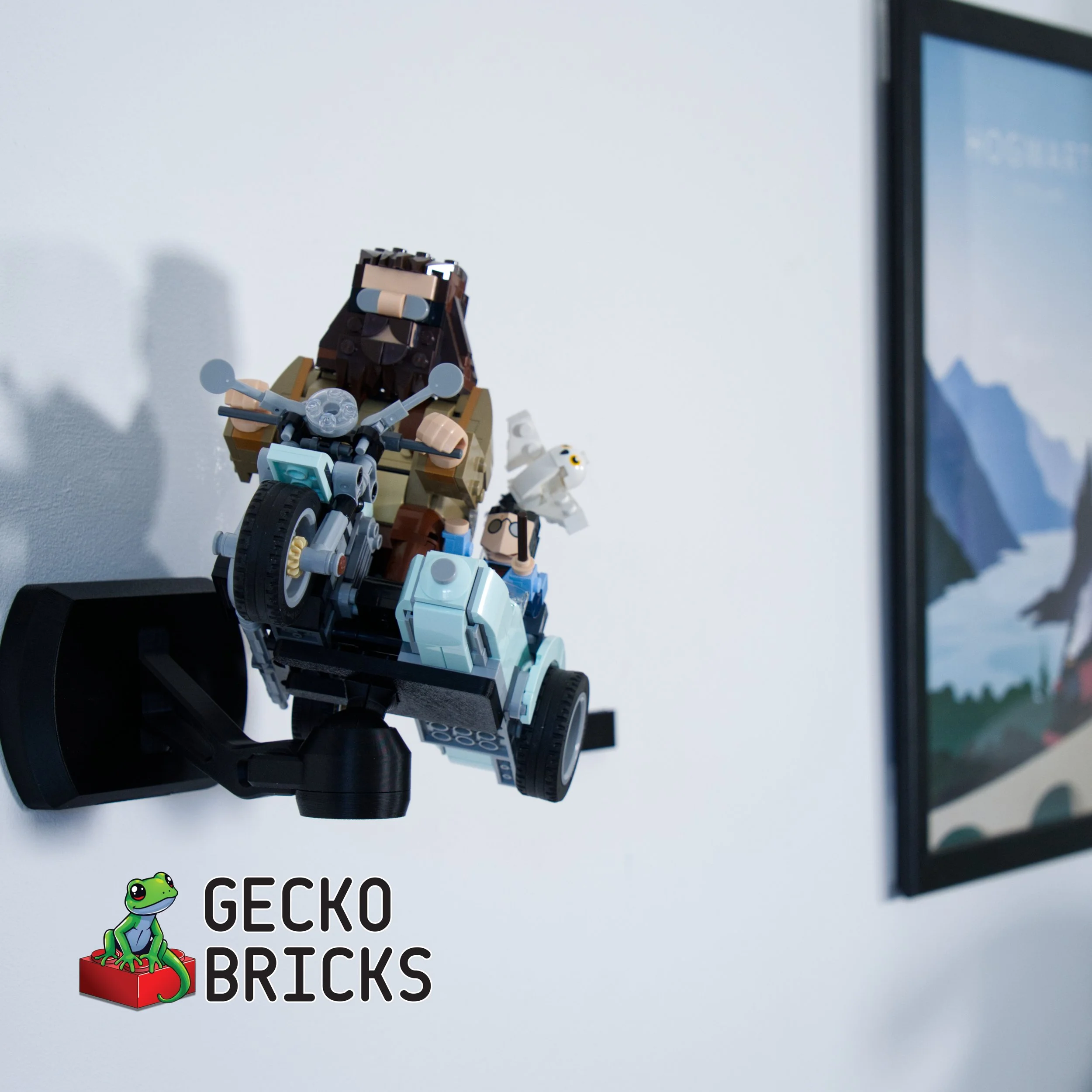 Close-up of a LEGO lion on a white surface with a black border, with a partially visible outlined logo and the words "GECKO BRICKS" beneath a colorful cartoon gecko sitting on a red box.