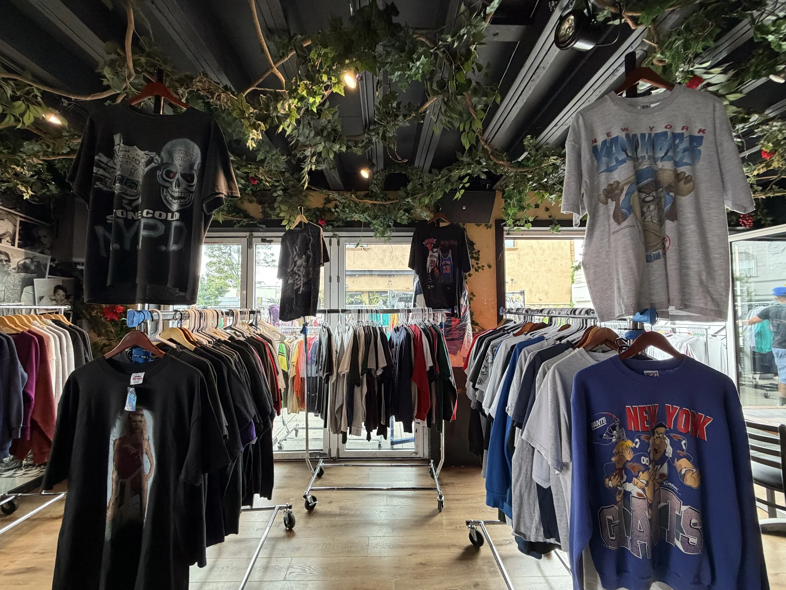 ReThreaded Co Vintage clothing display featuring vintage sports T-shirts and graphic tees on racks.