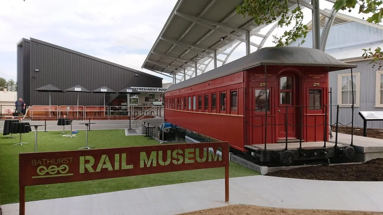 An old railway carriage and sign outside the railway museum
