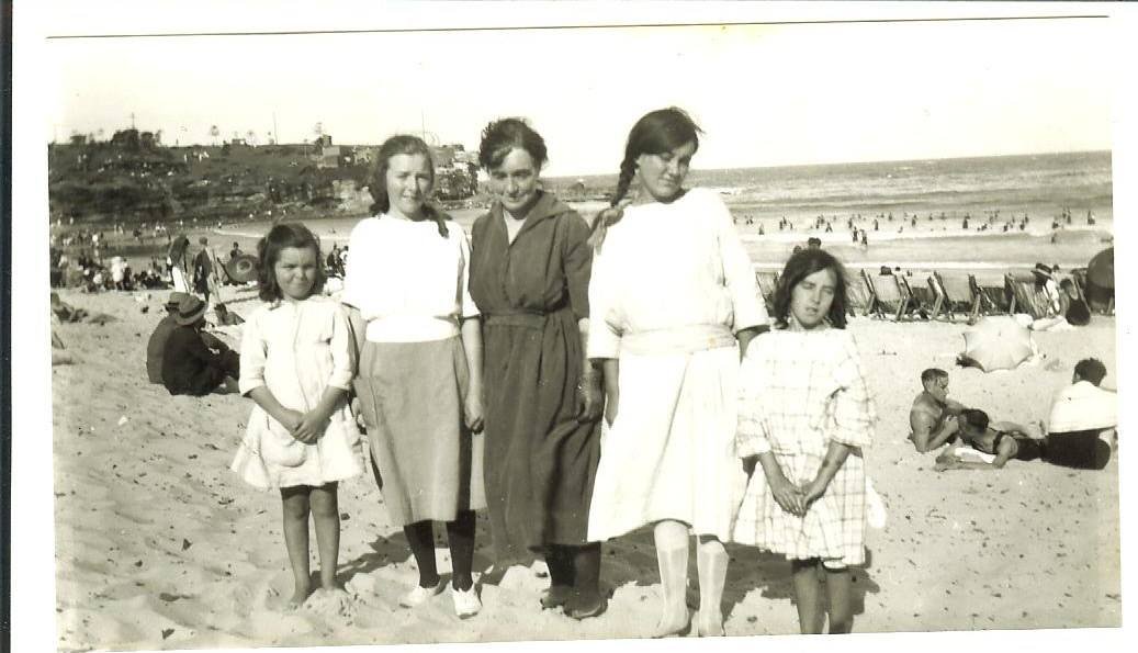An historical photo of a family of women and girls at the beach