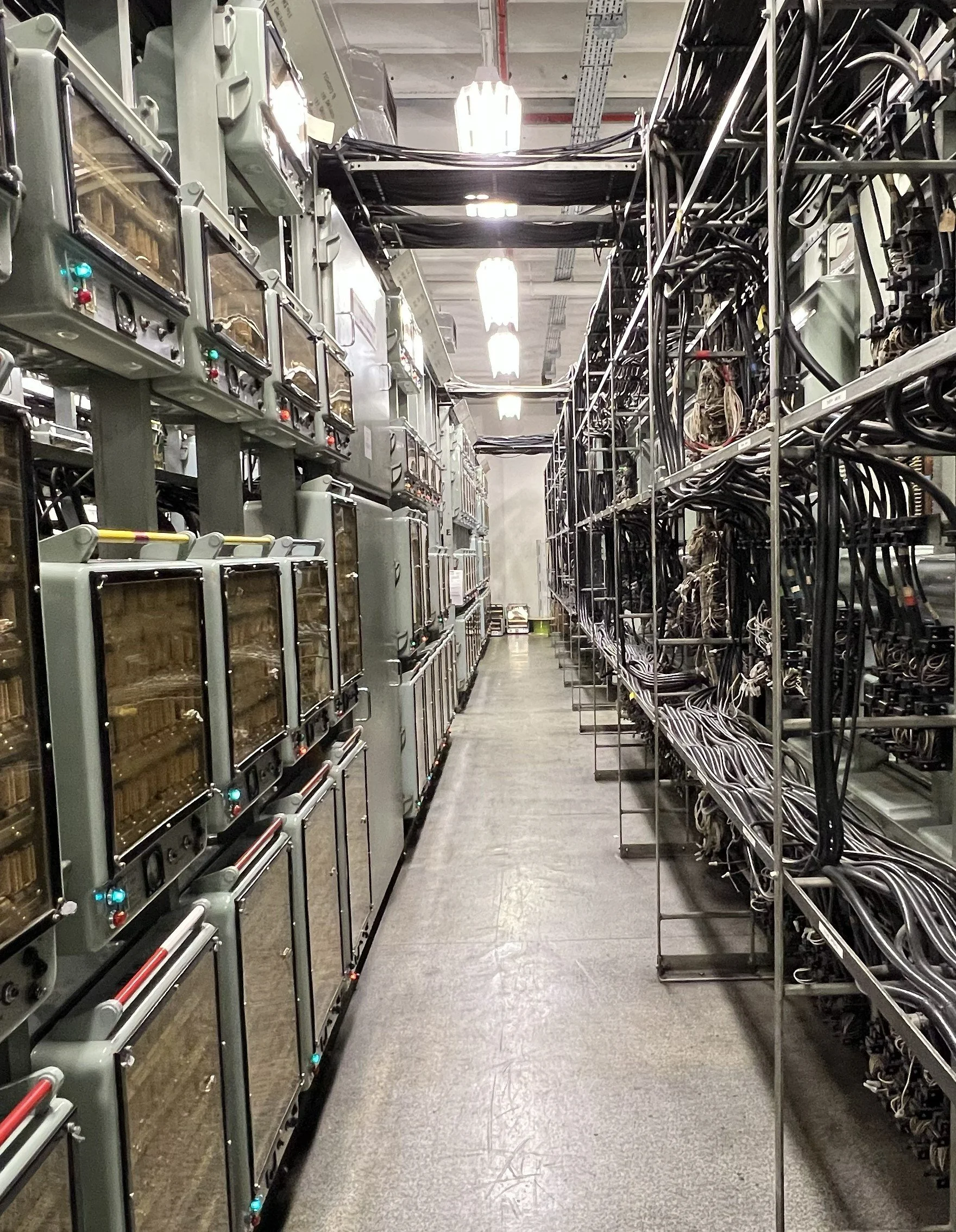 Electrical control panels and wiring racks in a server room or industrial facility.