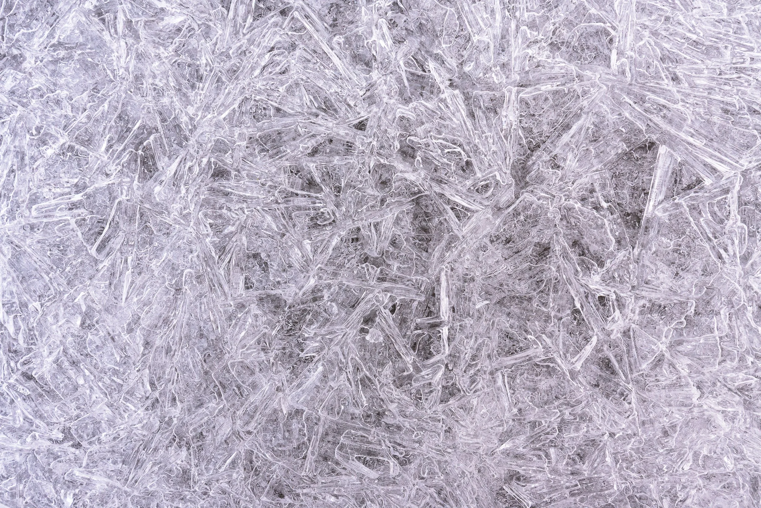 Close-up view of ice crystals with intricate and jagged patterns.