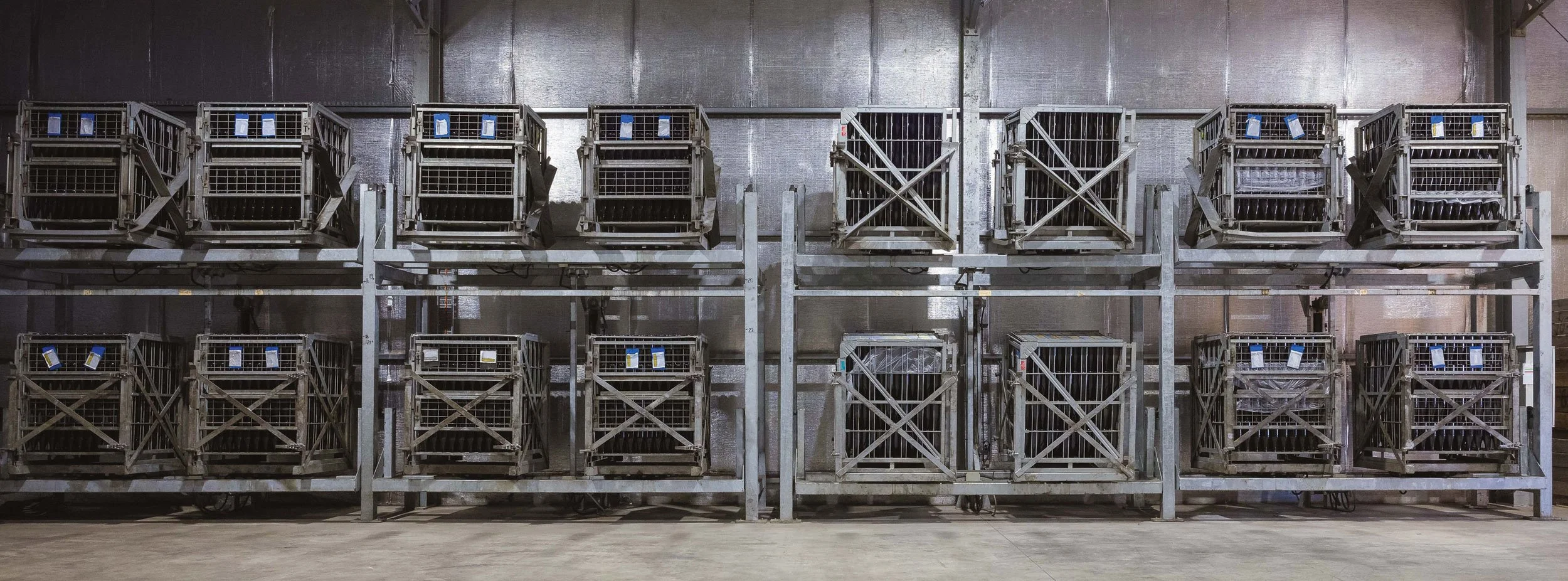 Row of empty metal shopping carts on a storage rack in Kilchurn warehouse storage area.