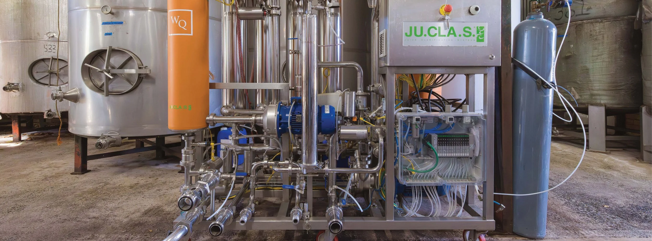 Industrial water treatment or filtration equipment with pipes, tanks, and controls.