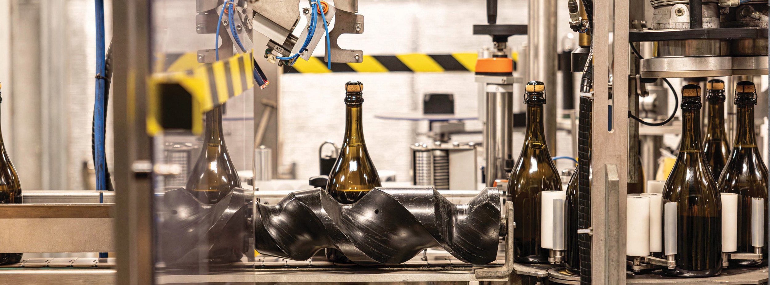 Sparkling bottles on a production line in Kilchurn Wines manufacturing facility.