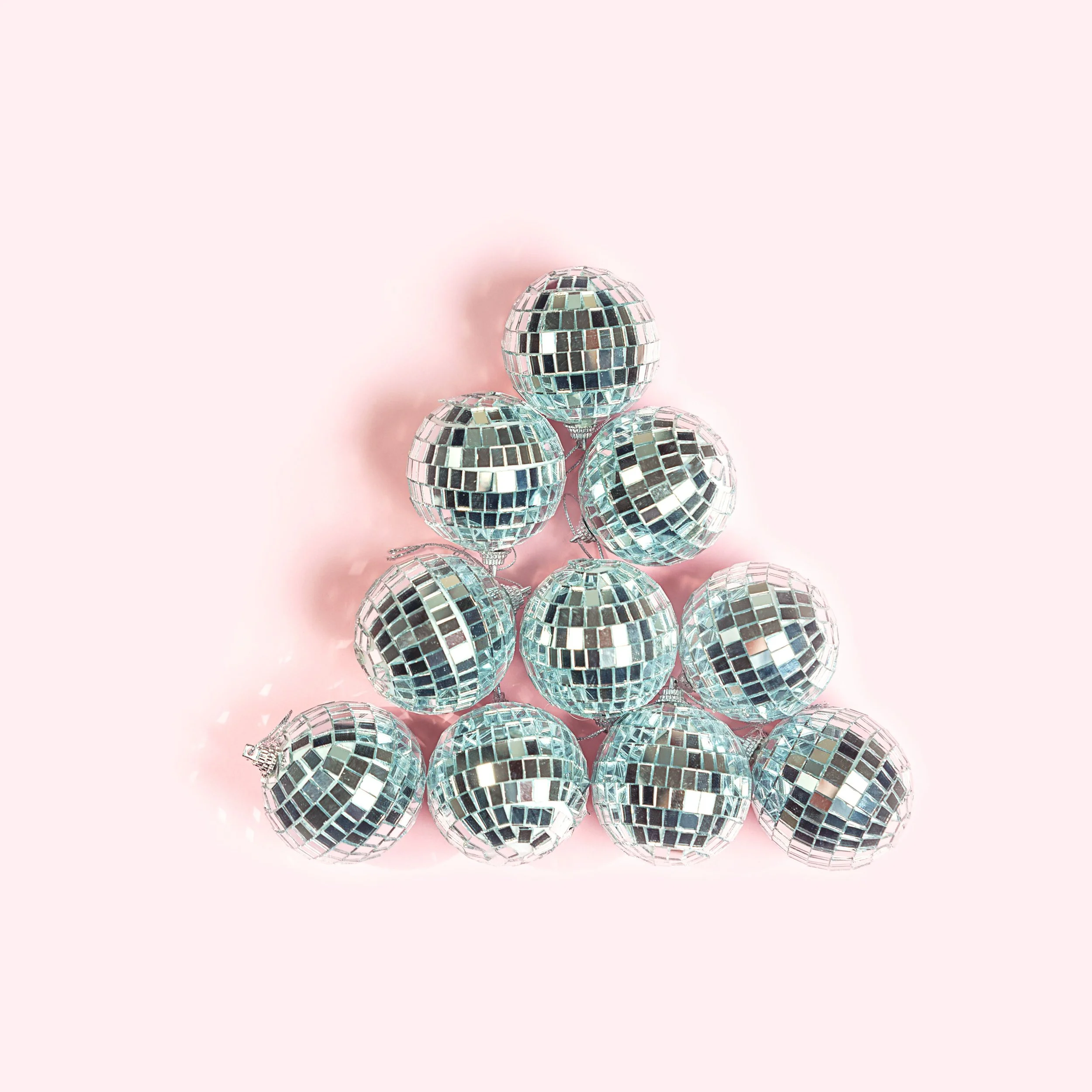 A pyramid of twelve small disco balls on a pink background. Image representing the CouplesTherapy.co Relationships Skills CLASS™.