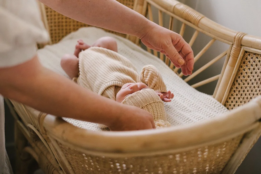 Baby in bassinet shot by a Sunshine Coast family photographer.