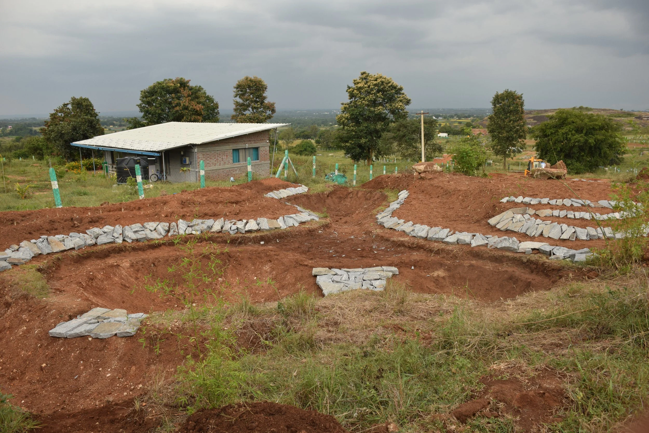 Pond 2B - reinforcing bunds with rocks