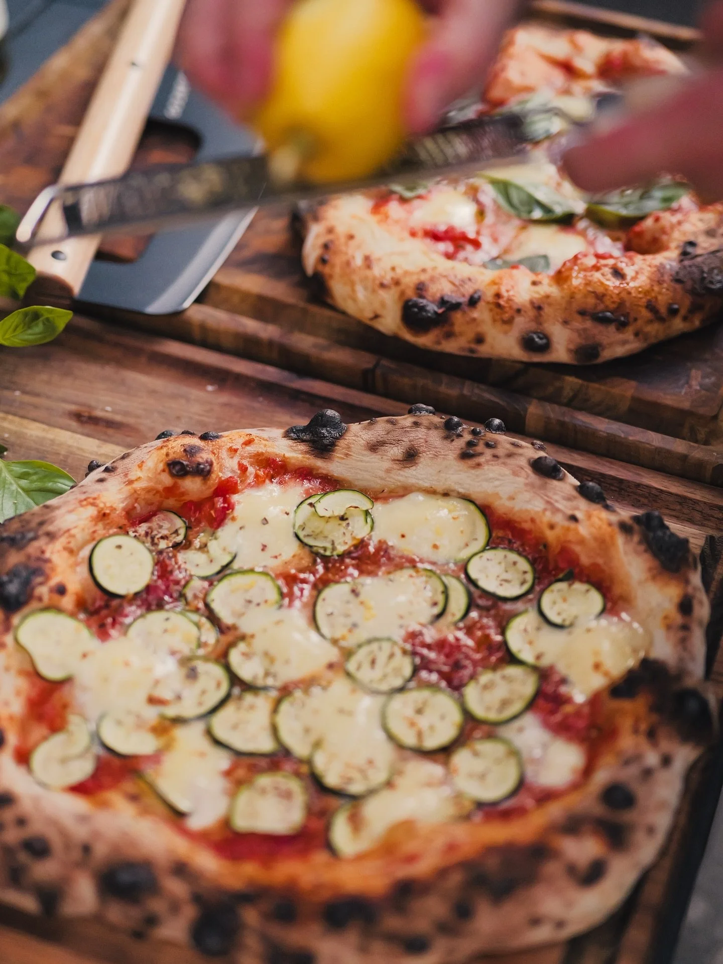 Why order pizza when you can fire up this wood-fired zucchini &amp; mozzarella beauty at home?

1. Stretch the dough (flour-dusted bench, rustic edges = perfect).
2. Spread homemade tomato sauce &ndash; simmered tomatoes, garlic + olive oil.
3. Top w