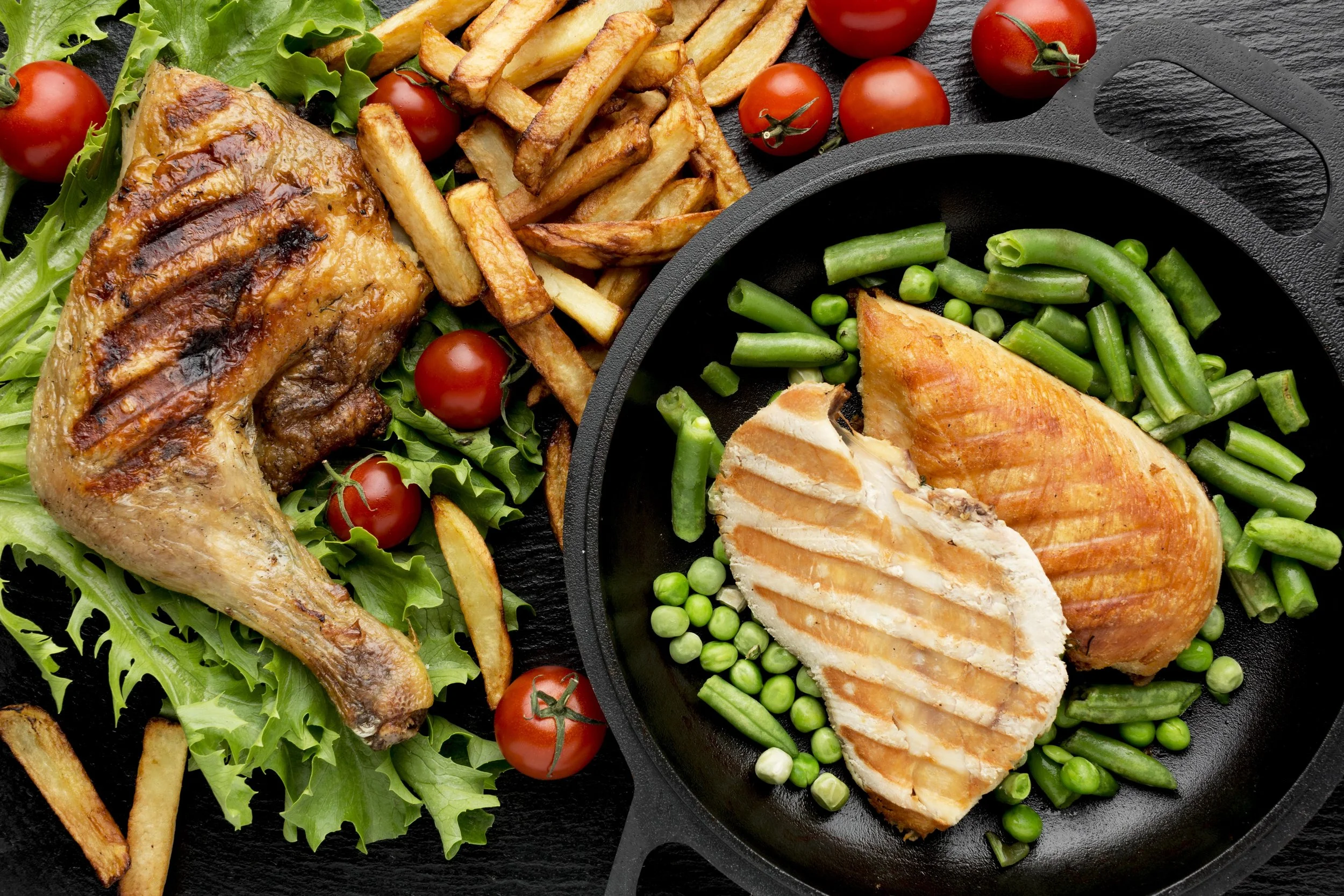 top-view-baked-chicken-cherry-tomatoes-with-fries-peas.jpg