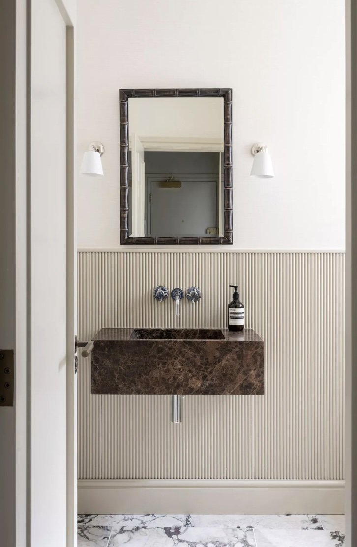 wall mounted marble sink, fluted panelled walls,  bamboo mirror, silk wallpape, calacatta viola marble floor