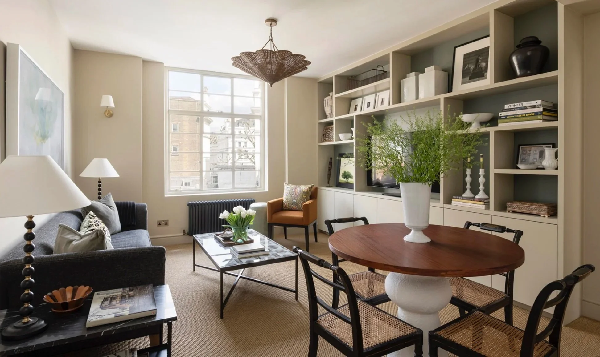 built in entertainment unit shelving, art display, sisal carpets, rattan ceiling light