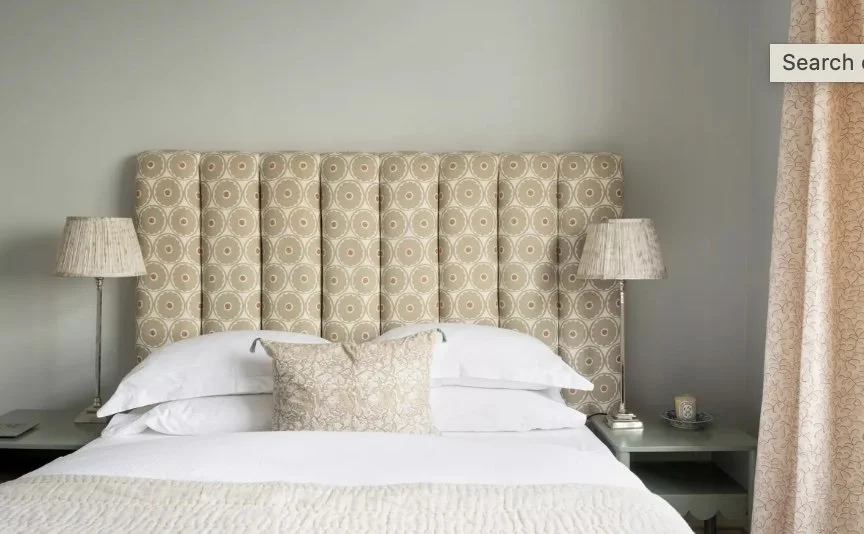 sky-blue bedroom with custom headboard and bedding