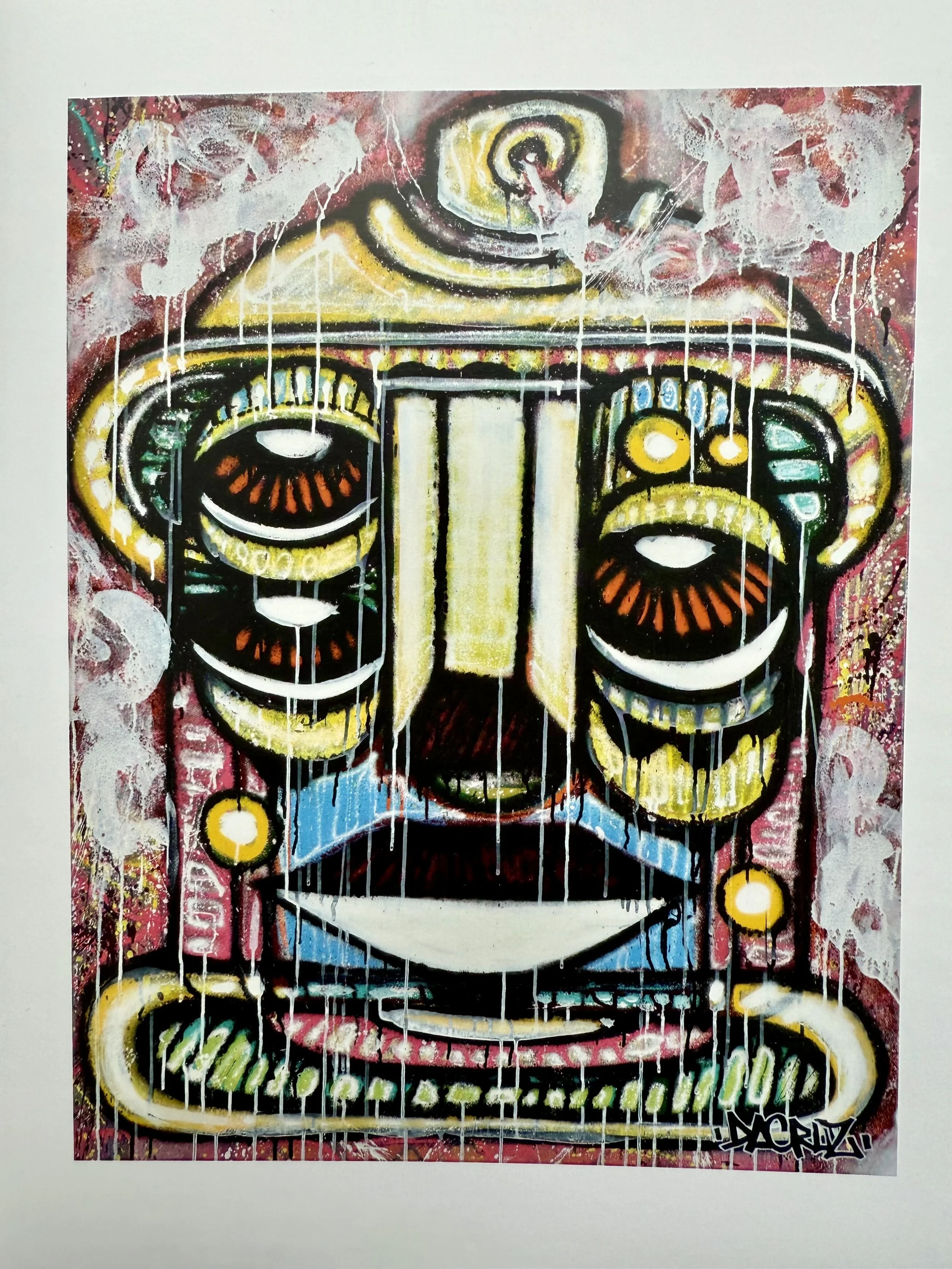 Une œuvre d'art de style graffiti représentant un masque tribal avec des couleurs vives, des traits noirs épaissis, et des gouttes de peinture qui tombent en cascade.