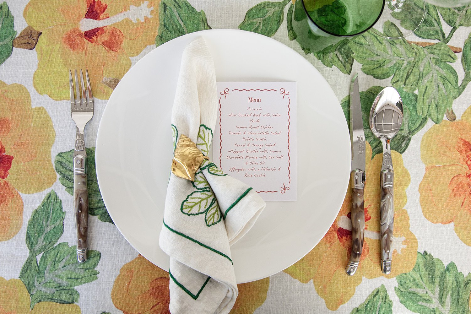 a place setting on a table with laguiole cutlery and bonnie and neil napery