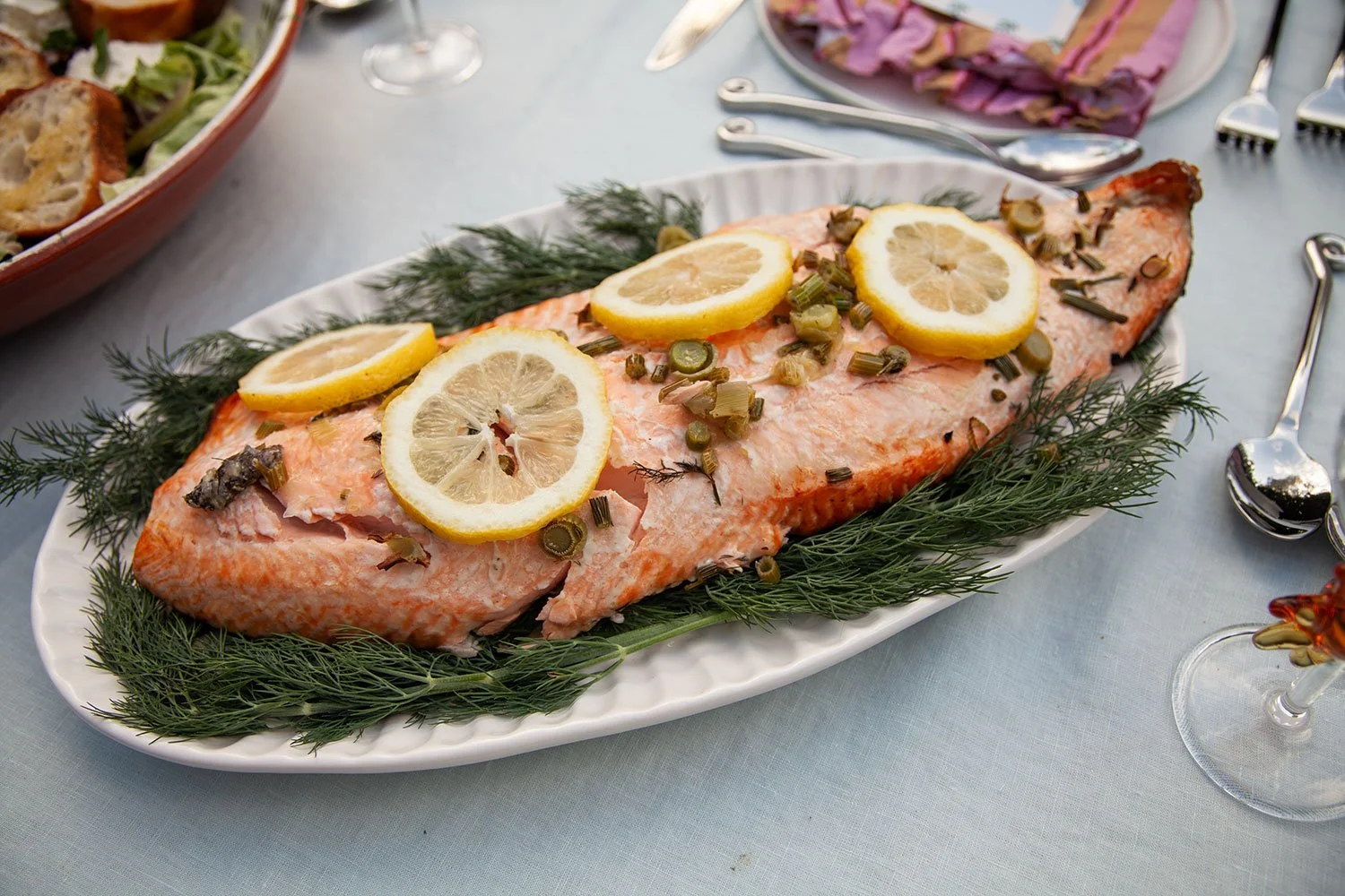 Baked salmon on a bed of dill with lemon