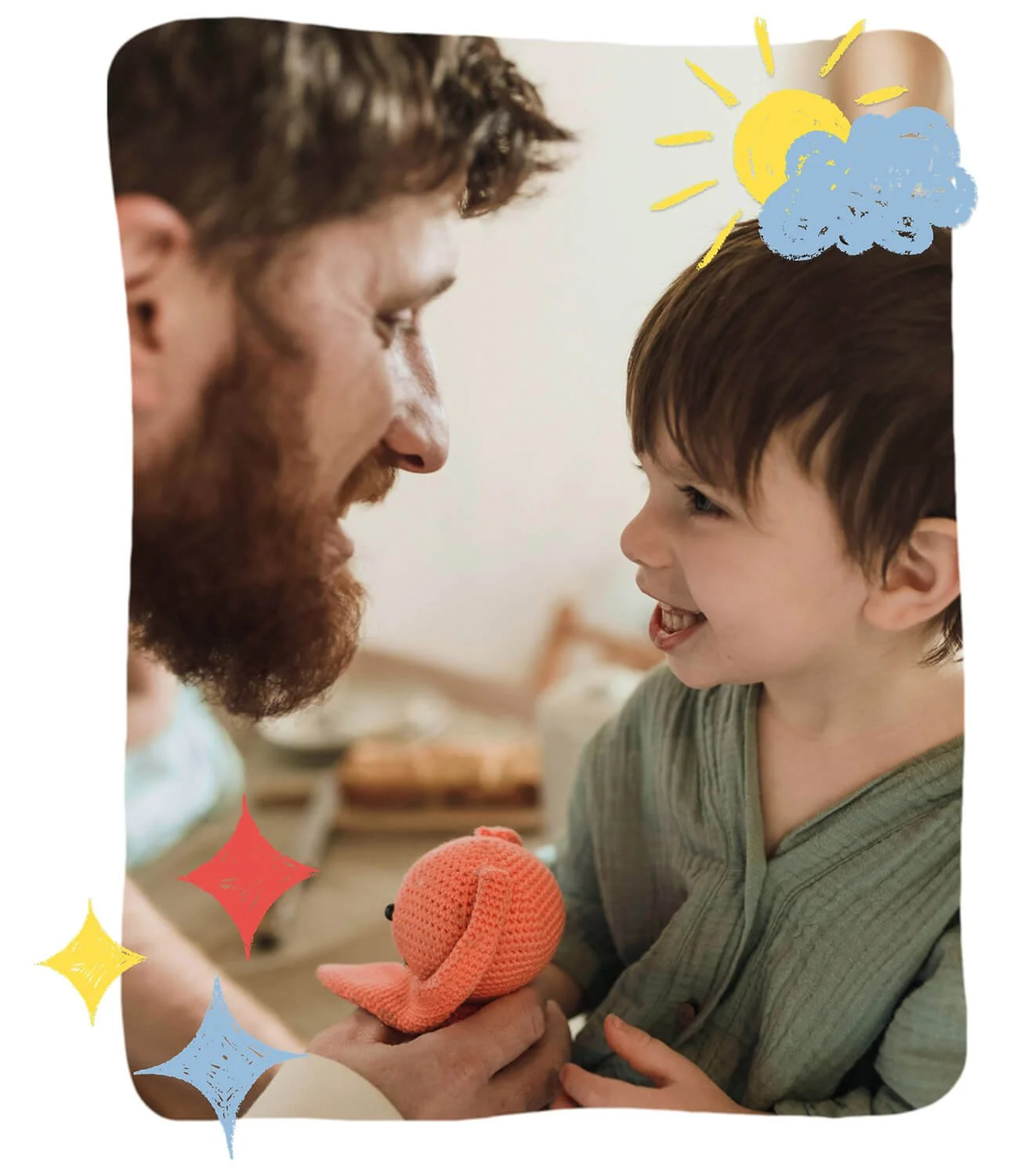 A man and a young boy are facing each other closely, smiling and engaging playfully. The man is holding a small, pink, knitted octopus toy. The image has colorful doodles of the sun, clouds, and sparkles around them.