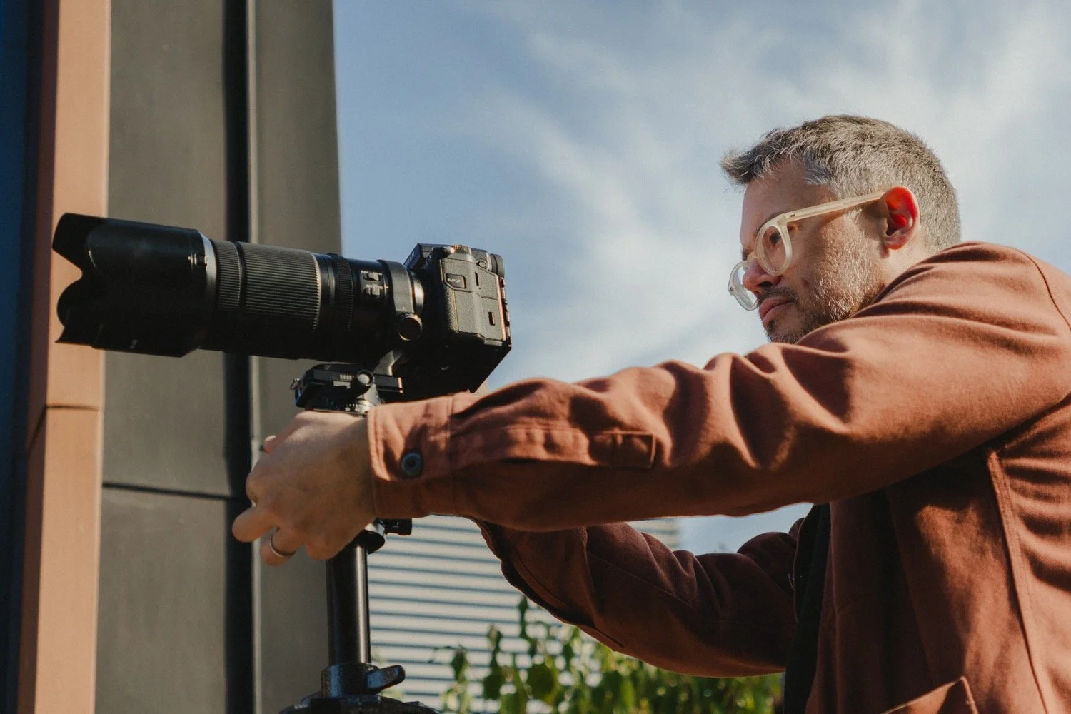 Matthew Smith levelling his tilt-shift lens against a blue sky