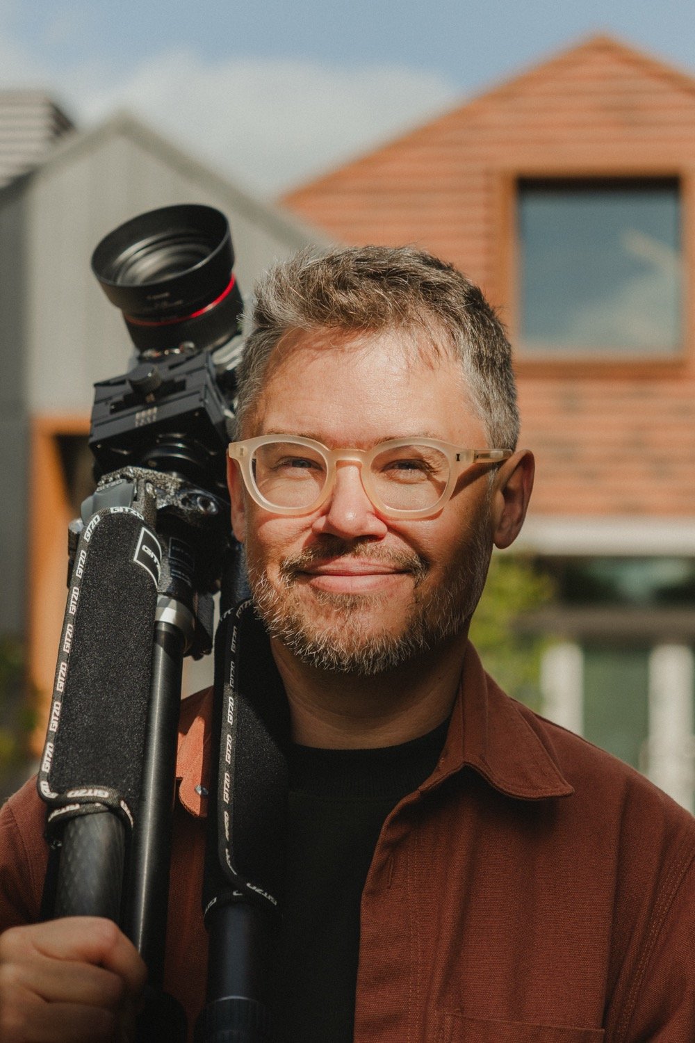 Matthew Smith, architectural photographer, smiling with his camera rig on his shoulder