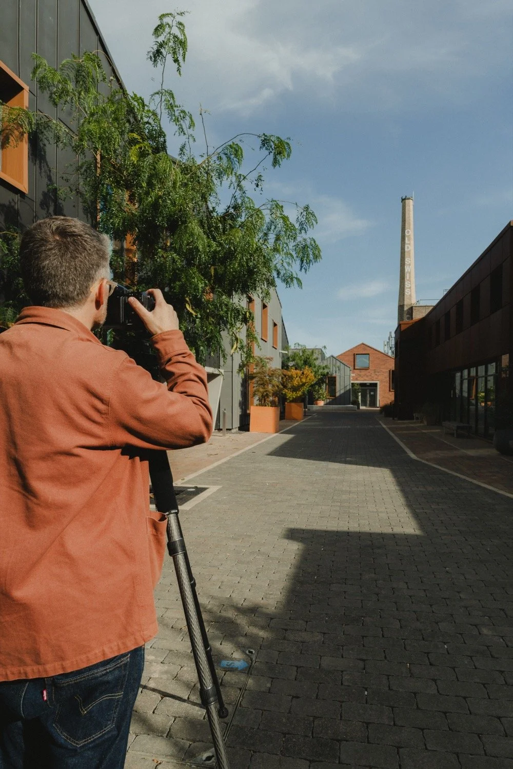 Matthew Smith photographing down a lane towards the Swiss Laundry chimney