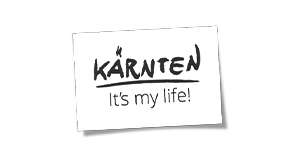 Schwarzer Hintergrund mit weißem Zettel, auf dem 'KÄRNTEN It's my life!' geschrieben steht.