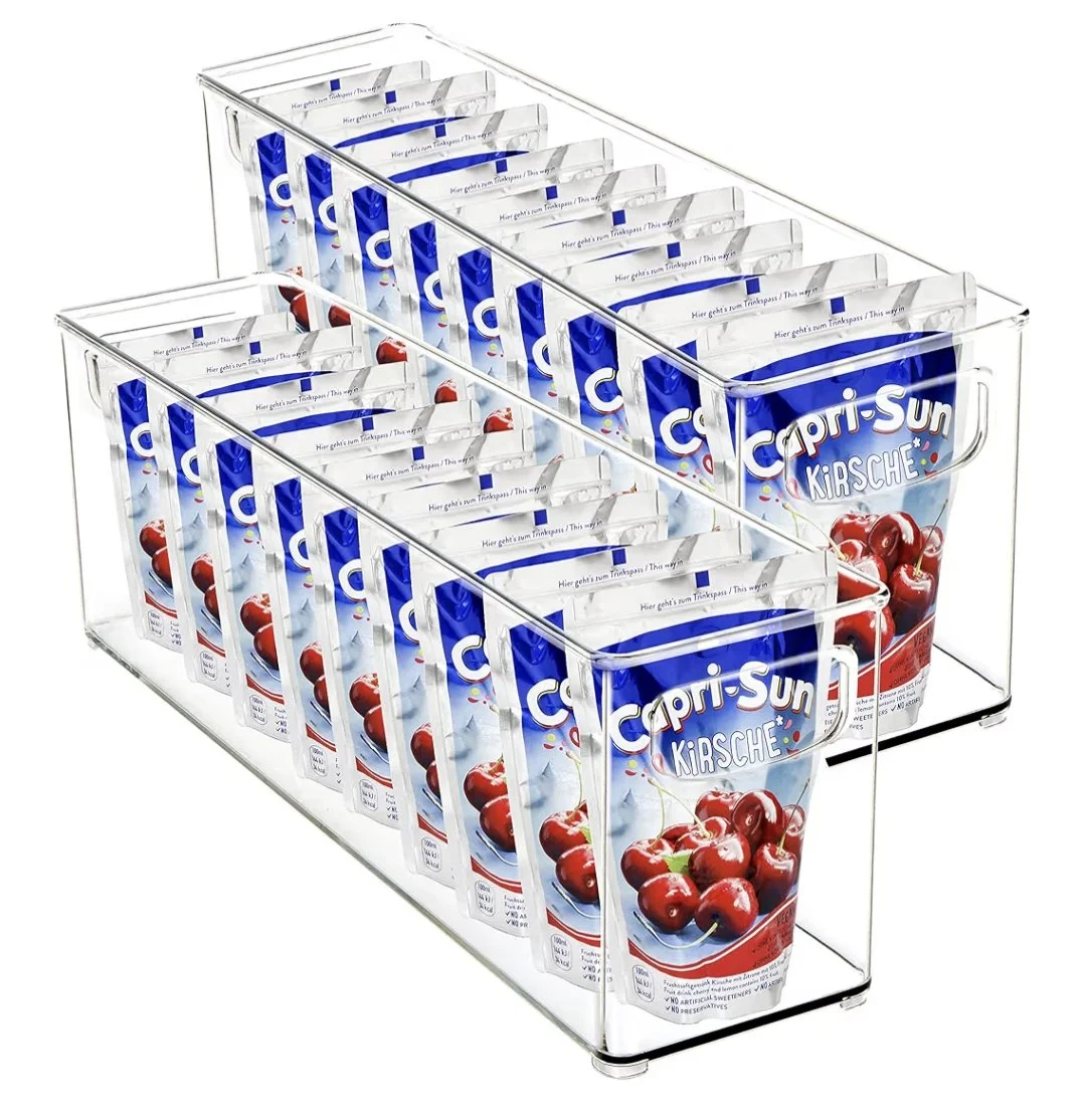 Clear acrylic display case holding multiple cartons of Capri-Sun Kirsche cherry-flavored juice drinks.
