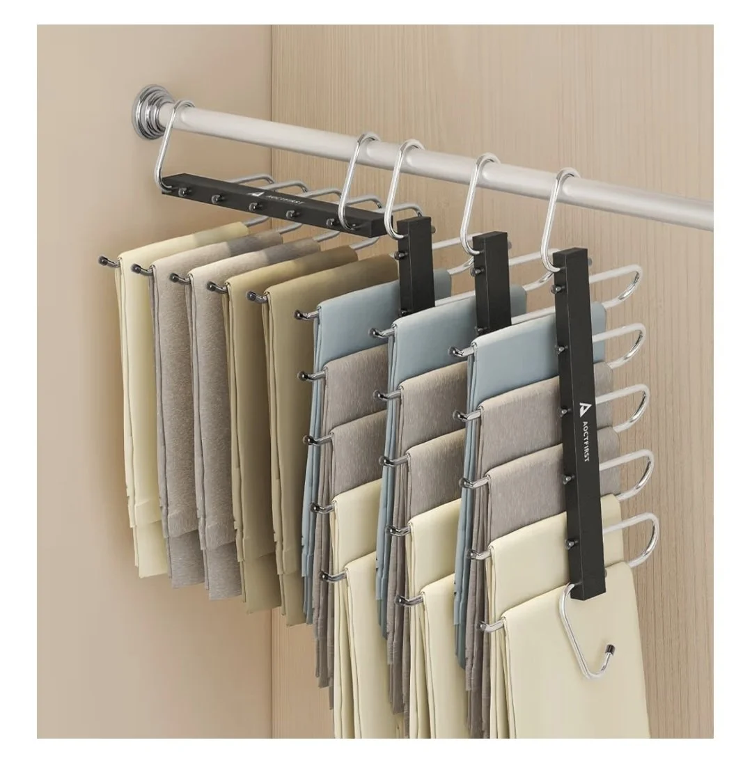 A closet rod with multiple hangers holding fabric swatches in neutral and pastel colors.