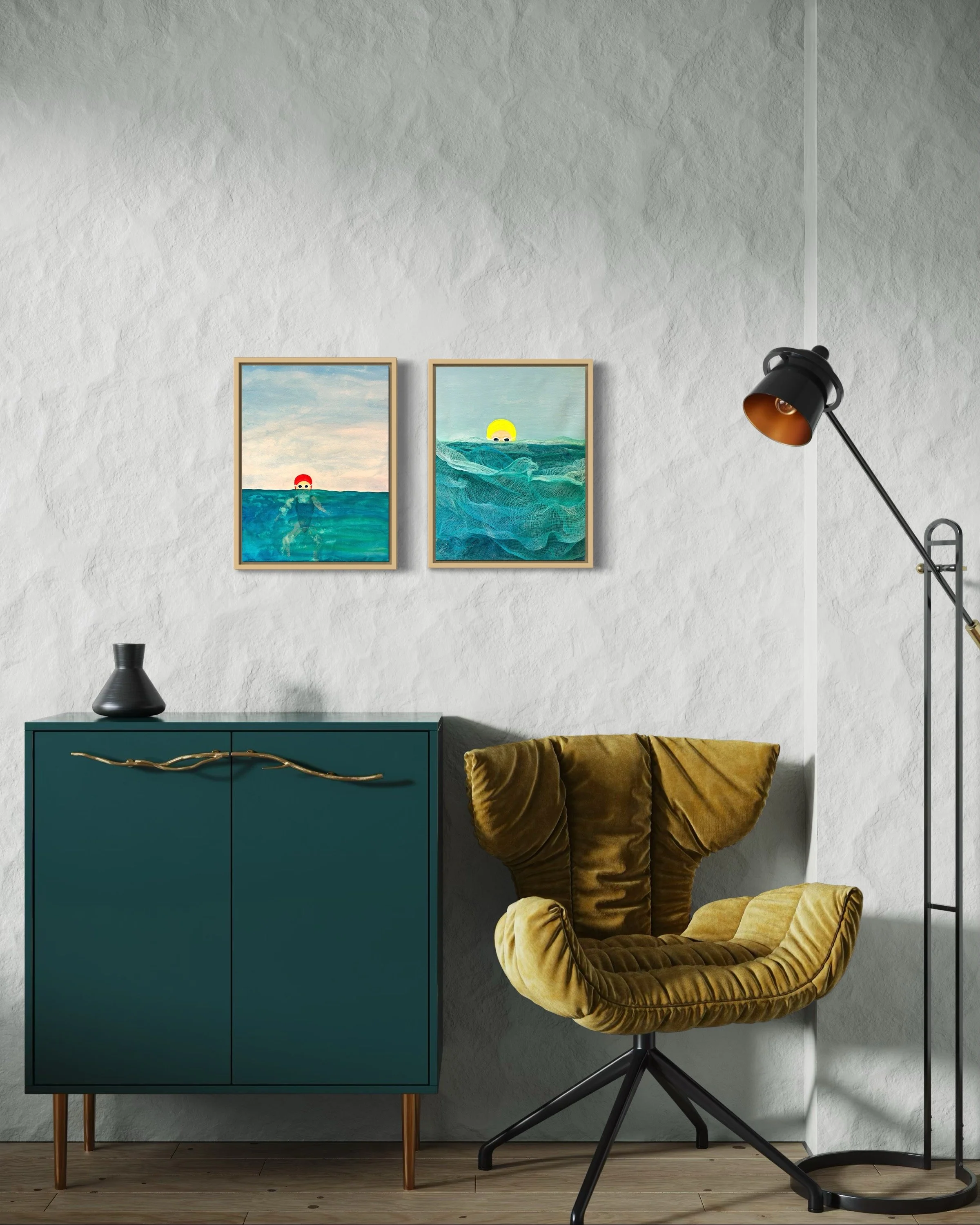 A cozy interior room with textured white walls, two framed ocean-themed paintings, a teal cabinet with a black vase on top, a mustard yellow velvet armchair, and a black floor lamp with an adjustable shade.