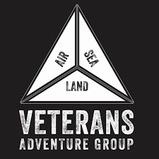 A triangular diagram with three sections labeled 'Air,' 'Sea,' and 'Land,' and the text 'Veterans Adventure Group' underneath.