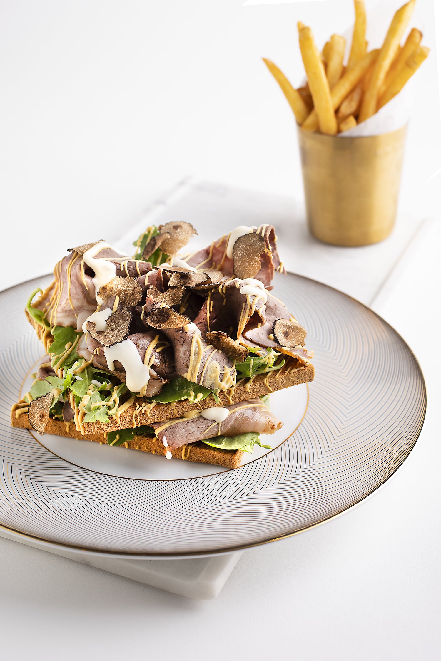 Open-faced sandwich with lettuce, ham, and truffle chips